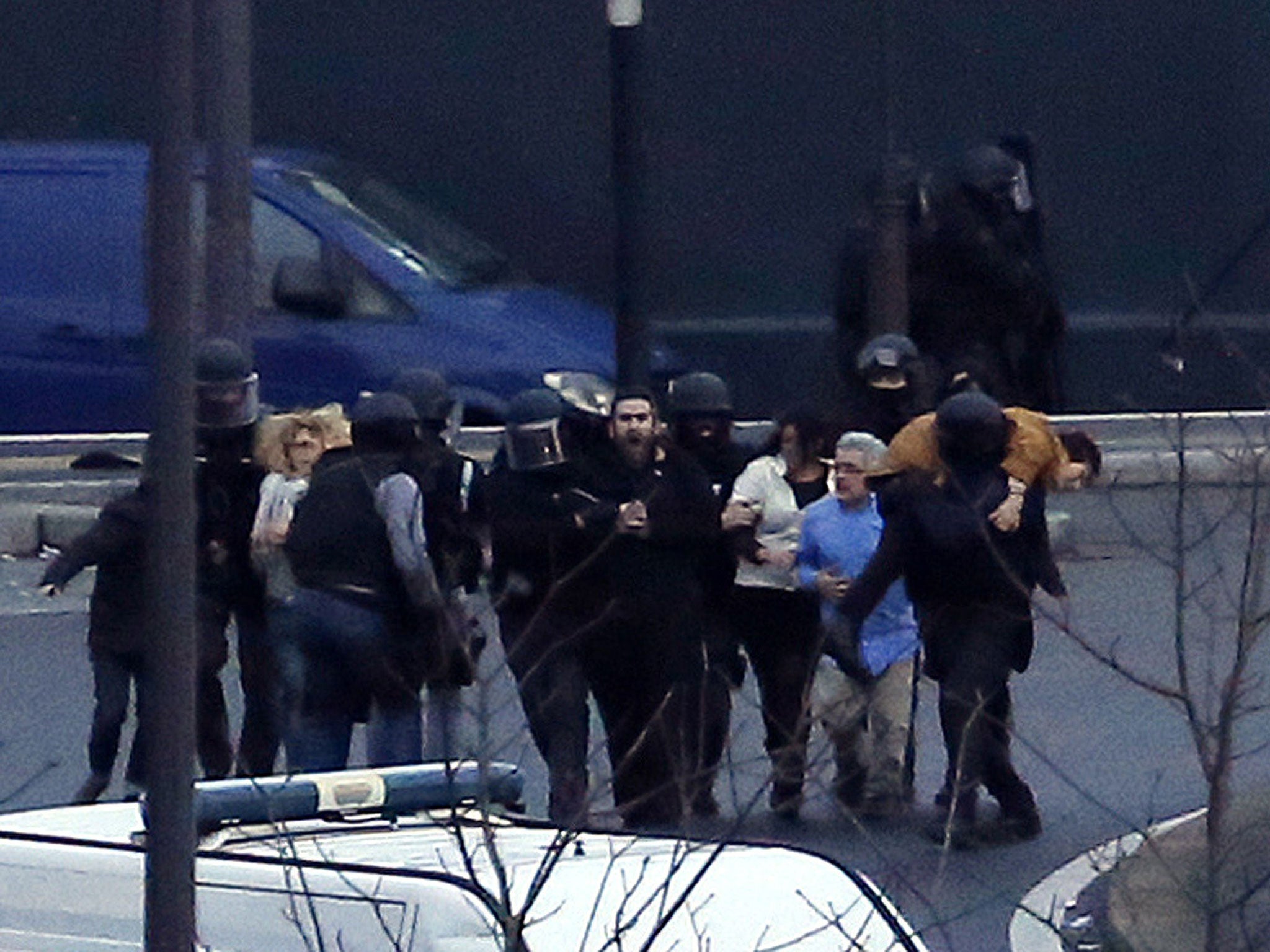 Members of the French police special forces evacuate the hostages after launching the assault at a kosher grocery store in Porte de Vincennes, eastern Paris