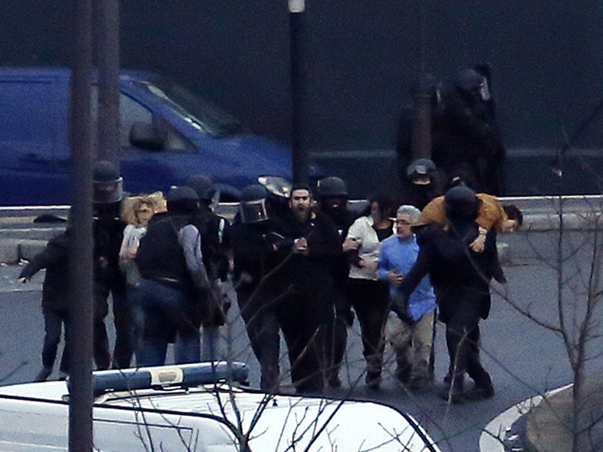 Members of the French police special forces evacuate the hostages after launching the assault at a kosher grocery store in Porte de Vincennes, eastern Paris 