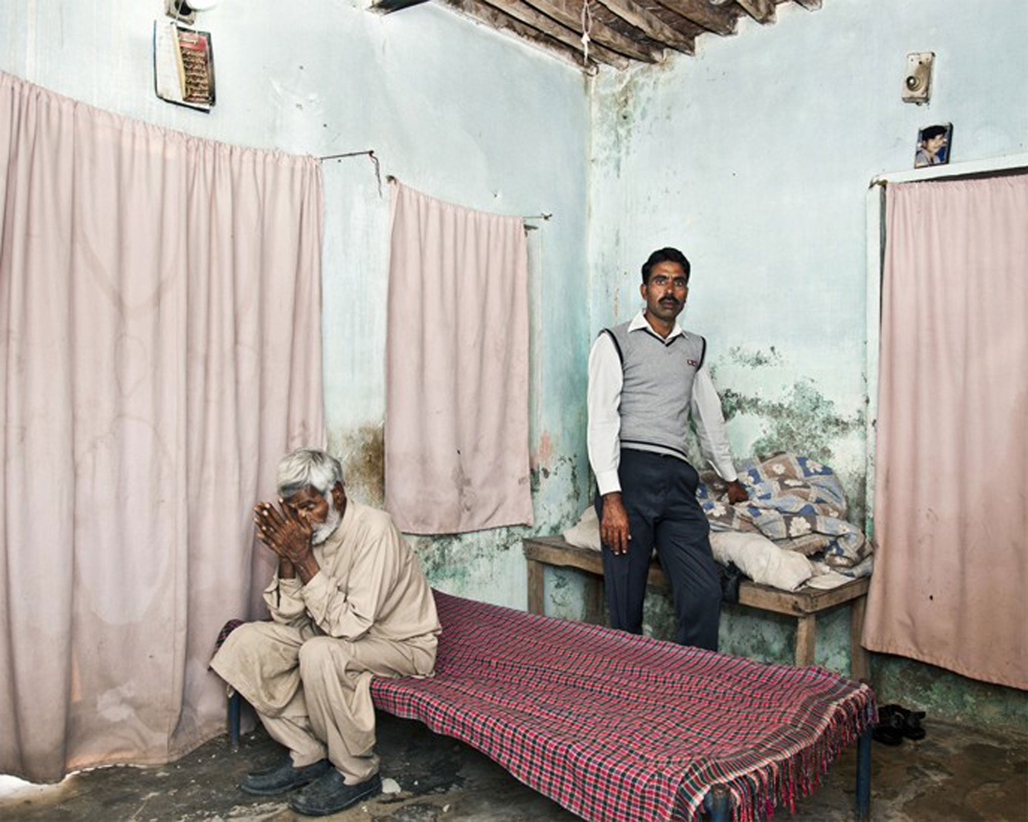 Kursheed Ahmed Khan and his father Rasheed (seated). Kursheed's brother Zulfiqar was sentenced to death and his family were asked to raise £34,000 for his release