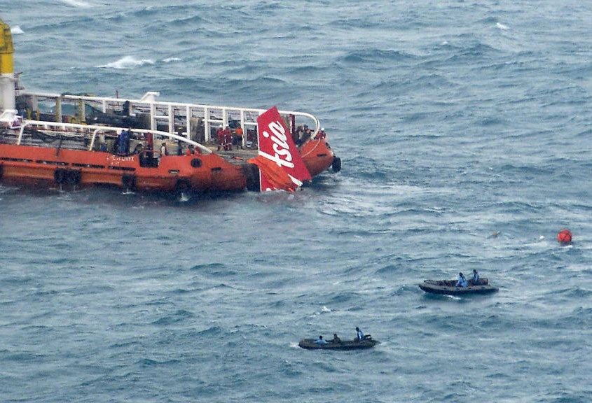 The tail of the crashed AirAsia plane being dragged out of the sea