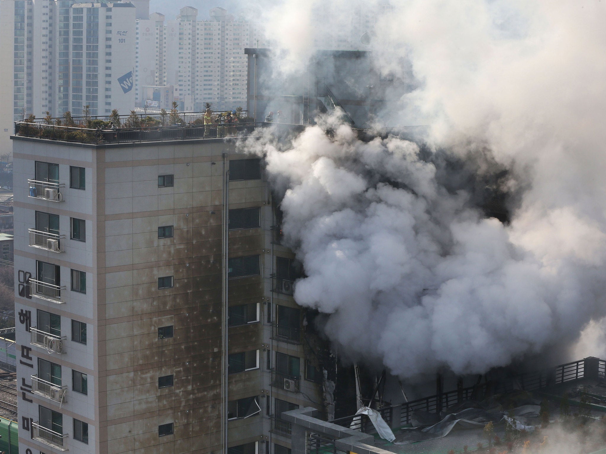 South Korean firefighters (rooftop) battle a blaze at a building which caught fire in Euijeongbu City, north of Seoul, on January 10, 2015.