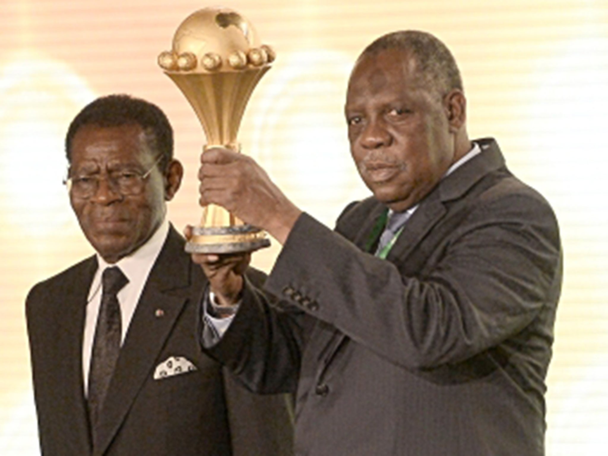 Fifa’s Issa Hayatou with the trophy at the draw