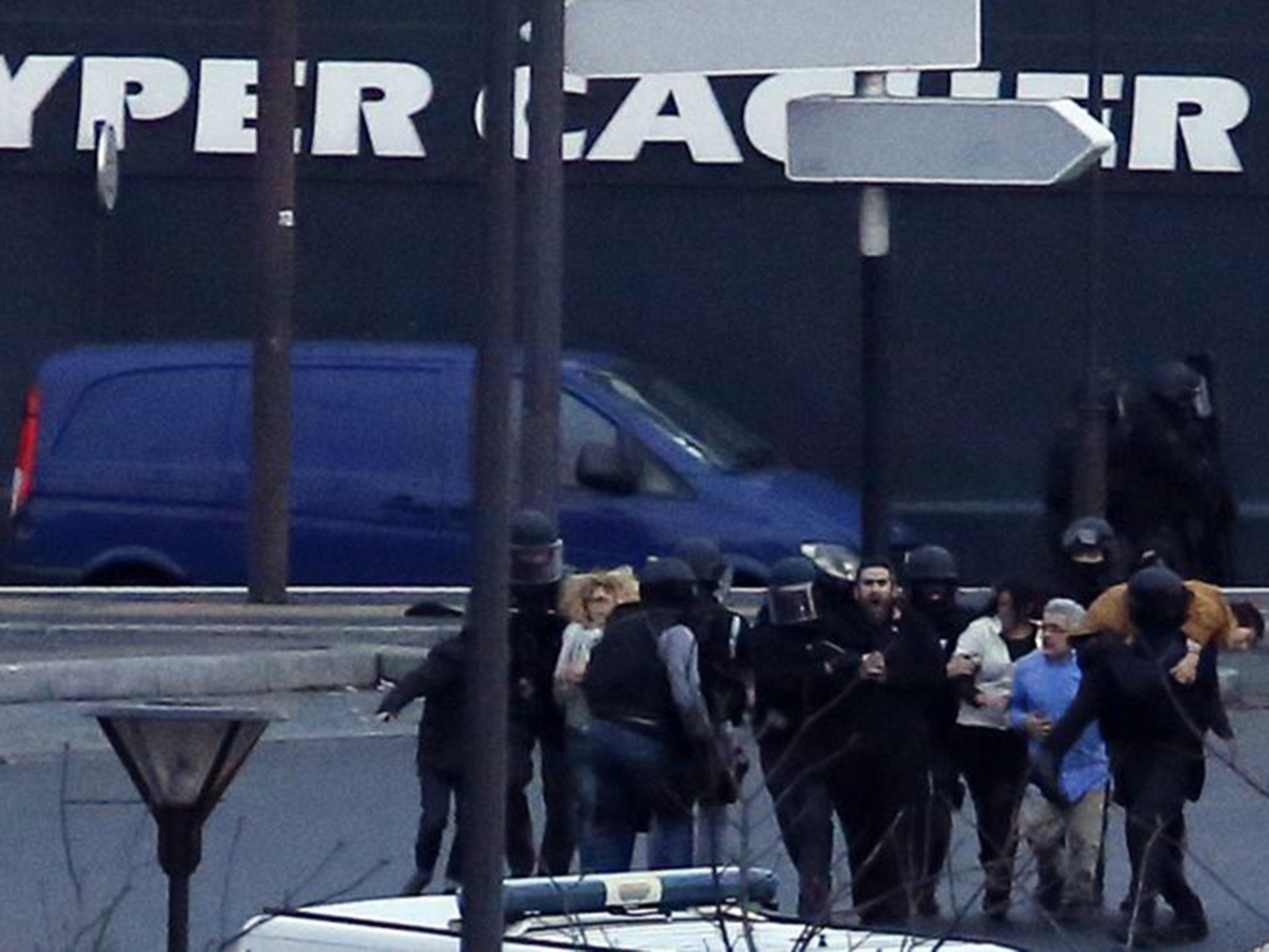 Hostages flee from the kosher supermarket on Friday