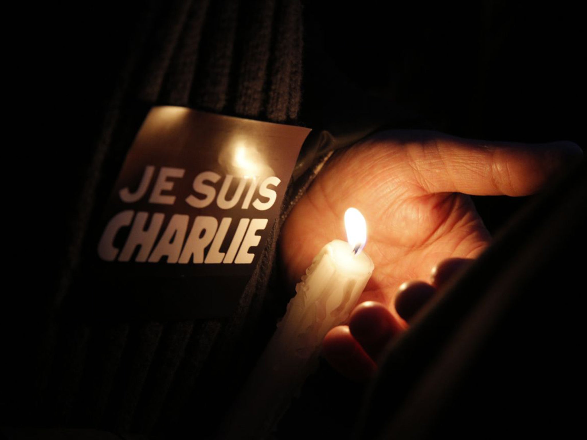 A candle held at Wednesday night’s vigil