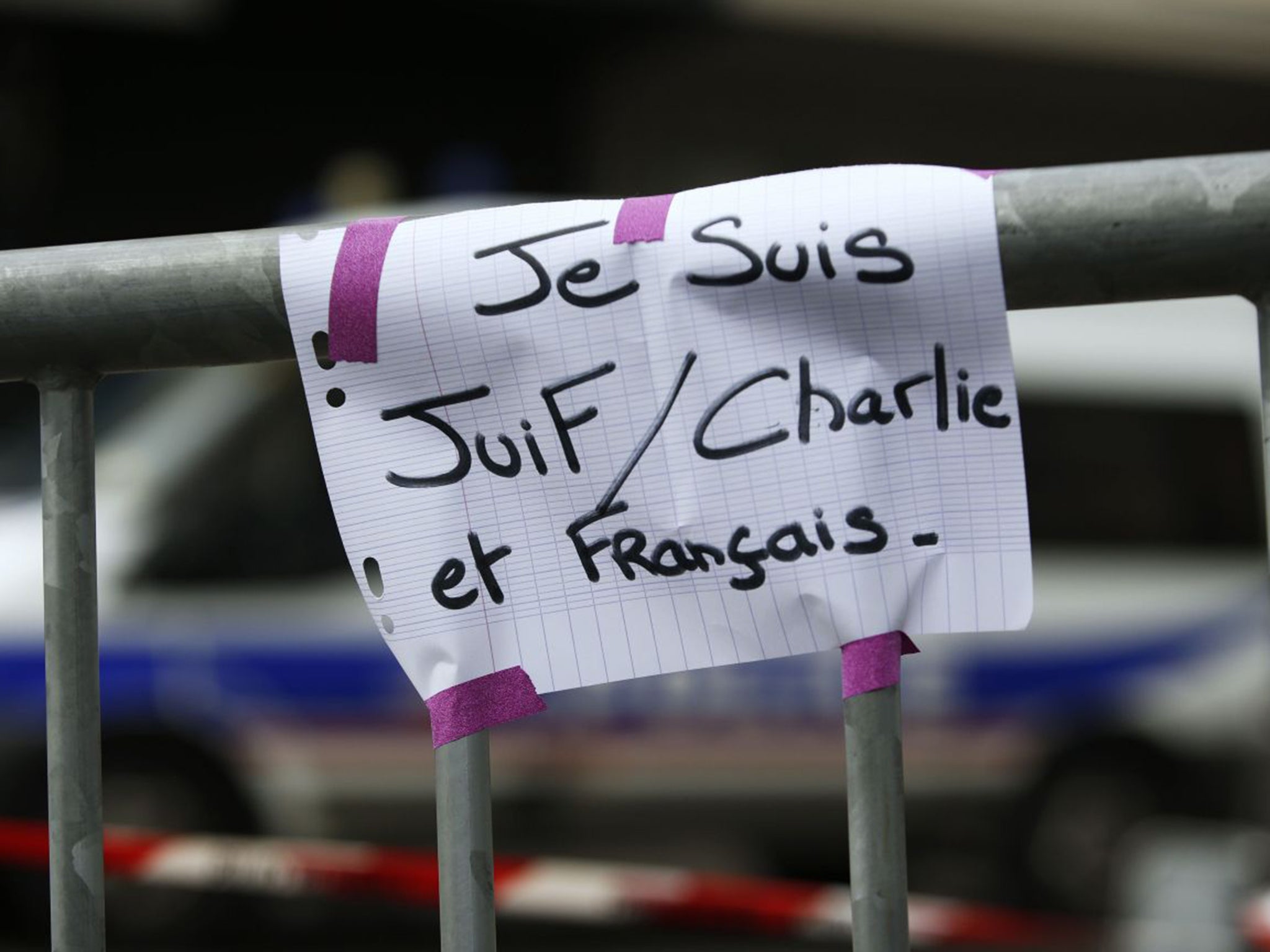 A message reading "I am Jewish, Charlie and French" taped to a security barrier near the kosher supermarket in Porte de Vincennes (AFP/Getty)
