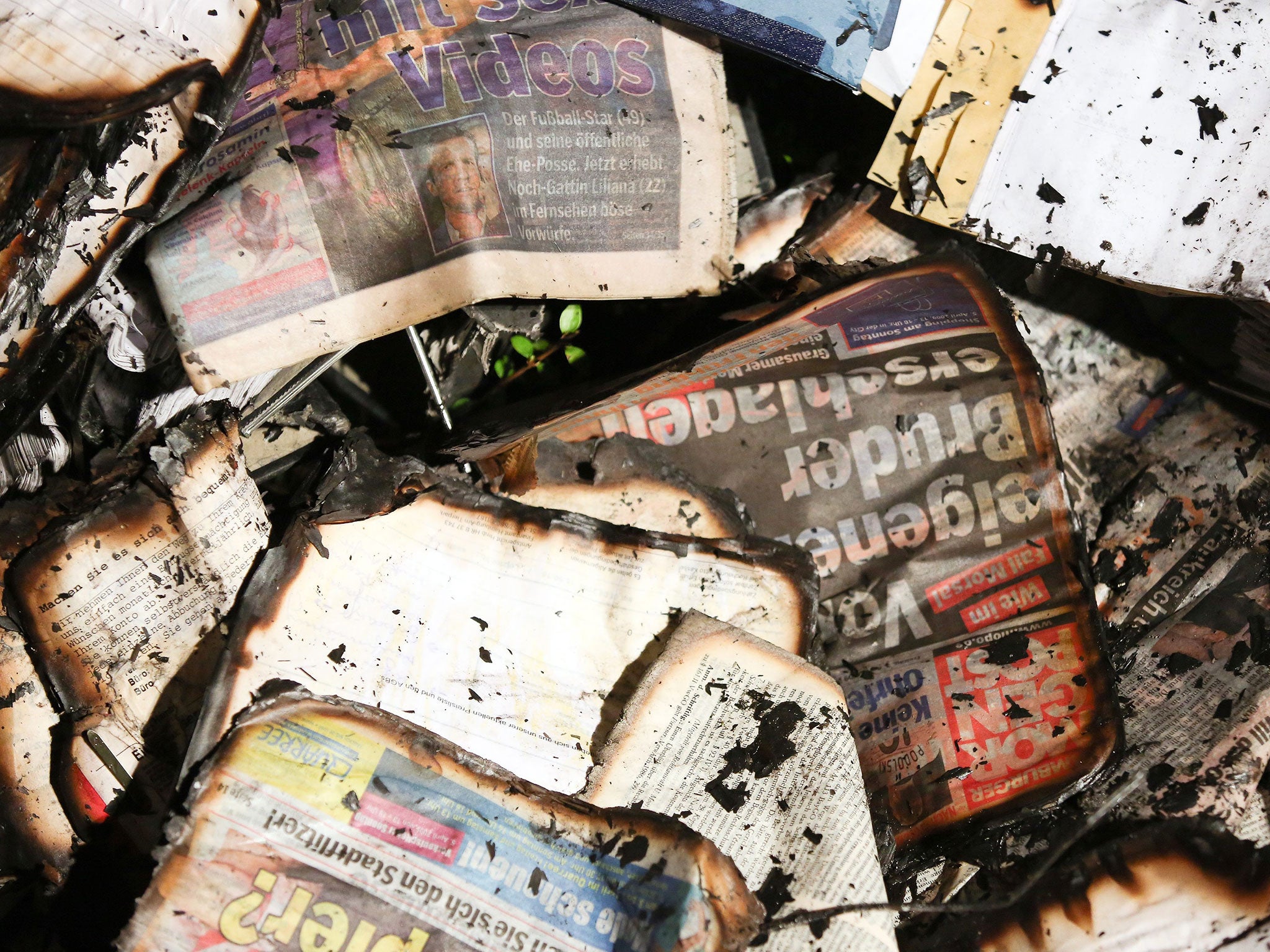 Fire-damaged newspapers at the scene of an arson attack on the headquarters of German daily Hamburger Morgenpost