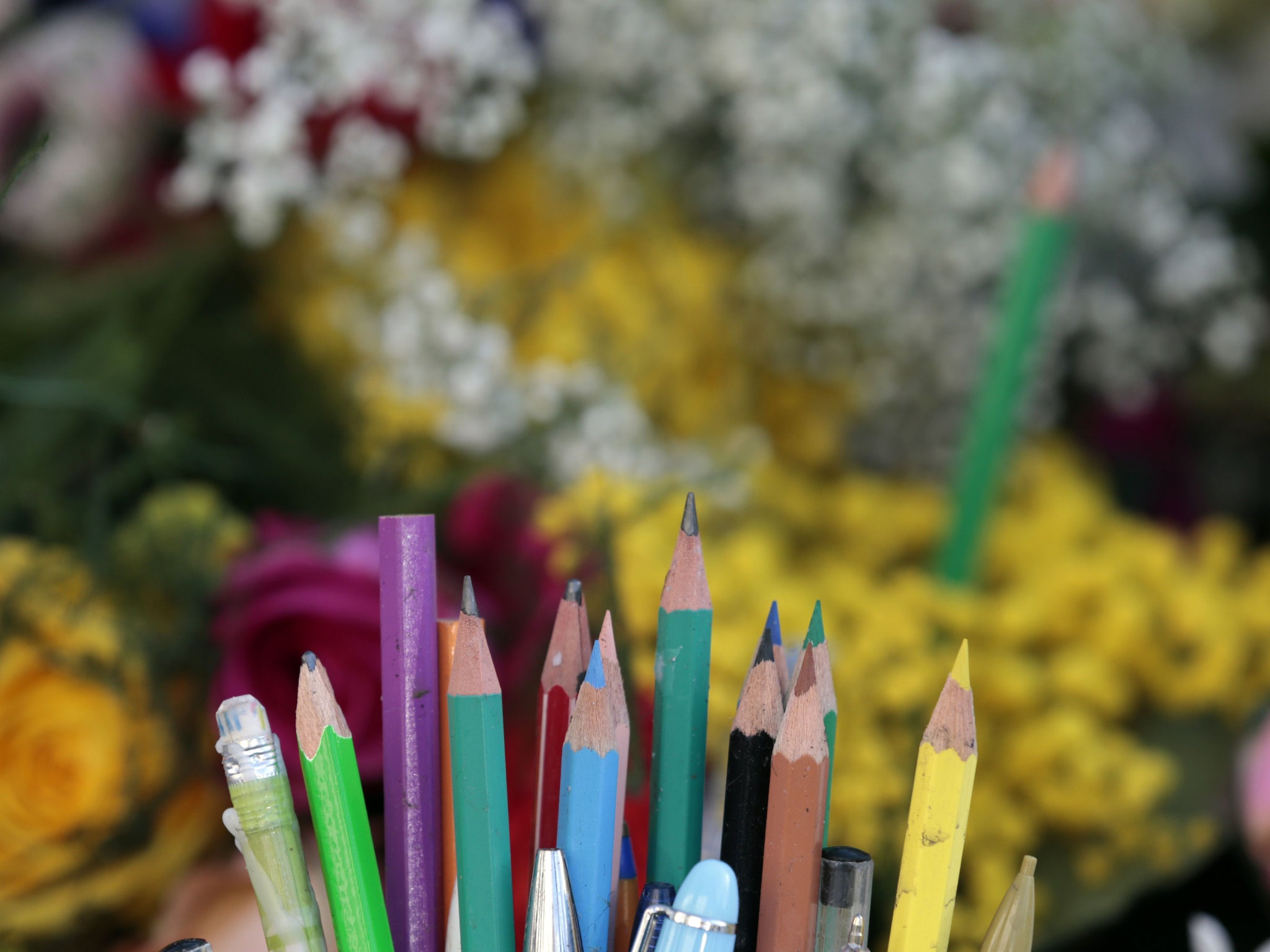 Pens and flowers are placed on the Place de Republique in Paris as people gather for the start of the huge march that will end at the Place de la Nation