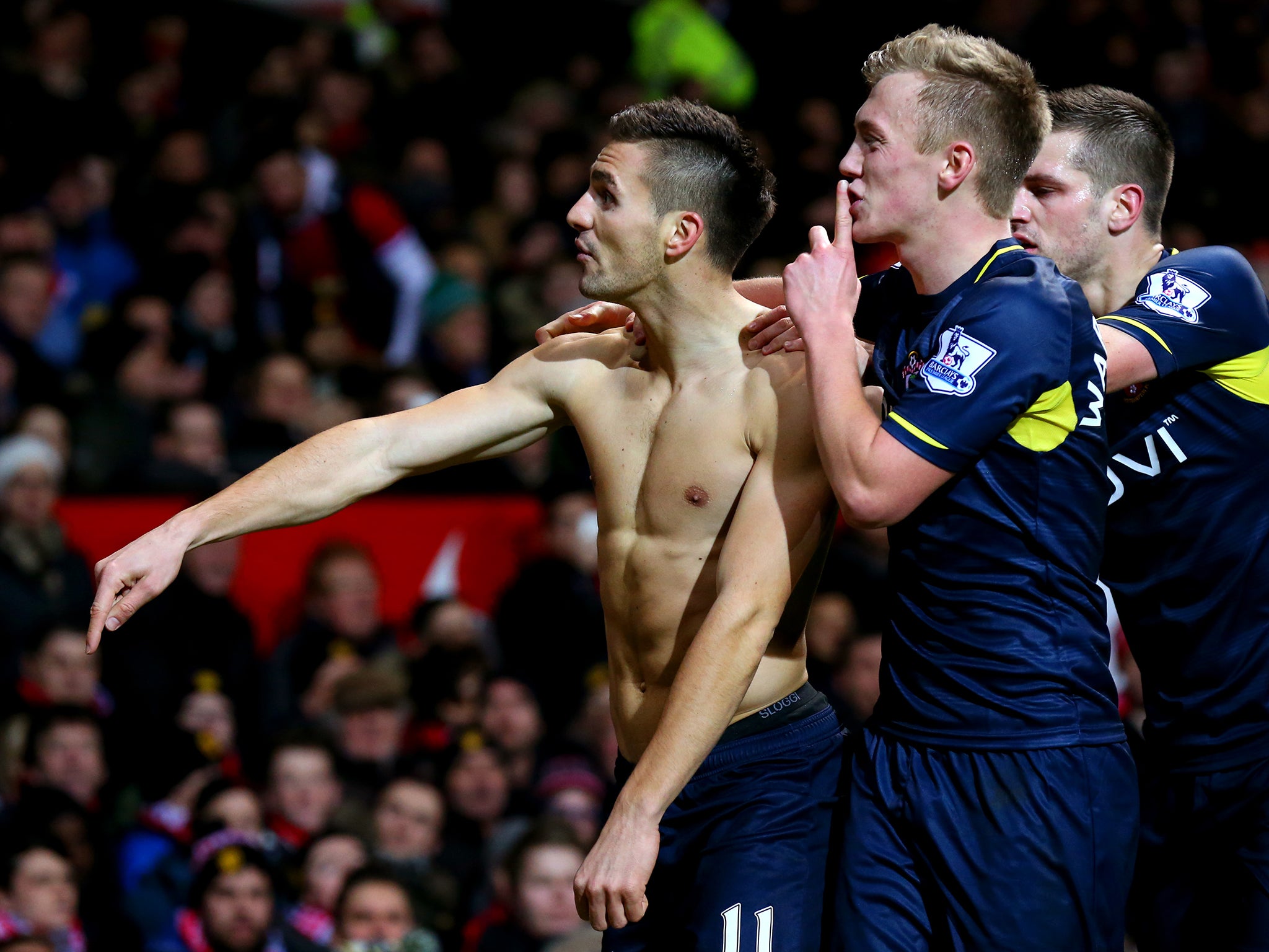 Dusan Tadic celebrates the opening goal at Old Trafford