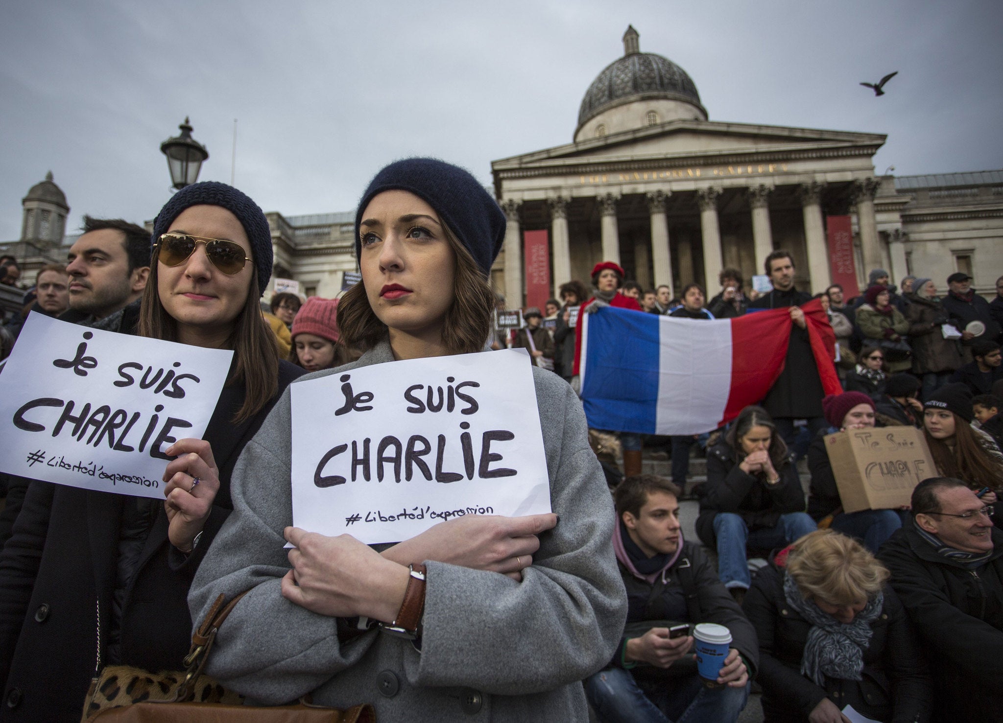 People gather in Trafalgar Square to show their respect to victims of the terrorist attacks in Paris on January 11, 2015 in London, England