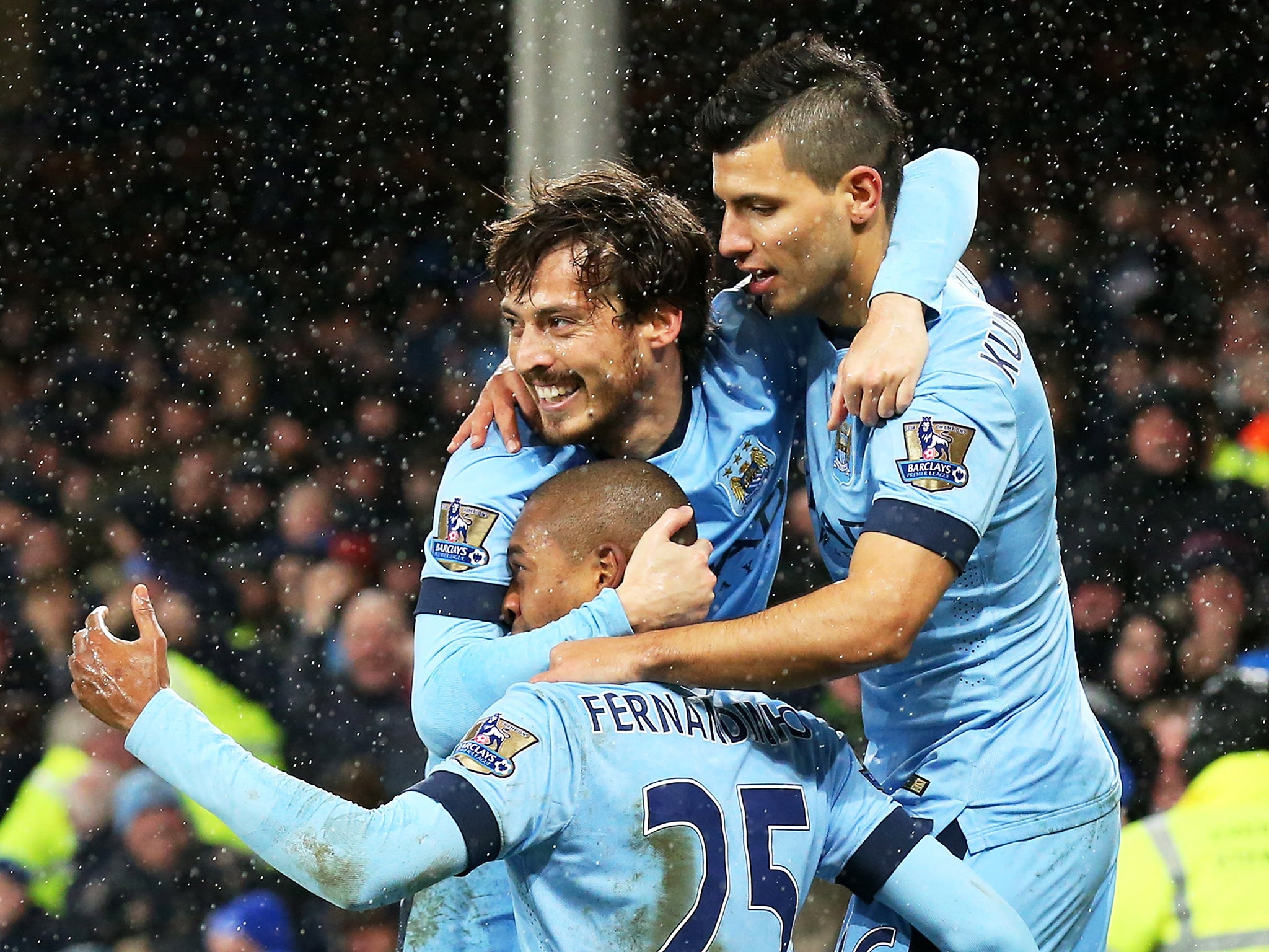 Fernandinho of Manchester City celebrates with teammates David Silva and Sergio Aguero after scoring the opening goal against Everton