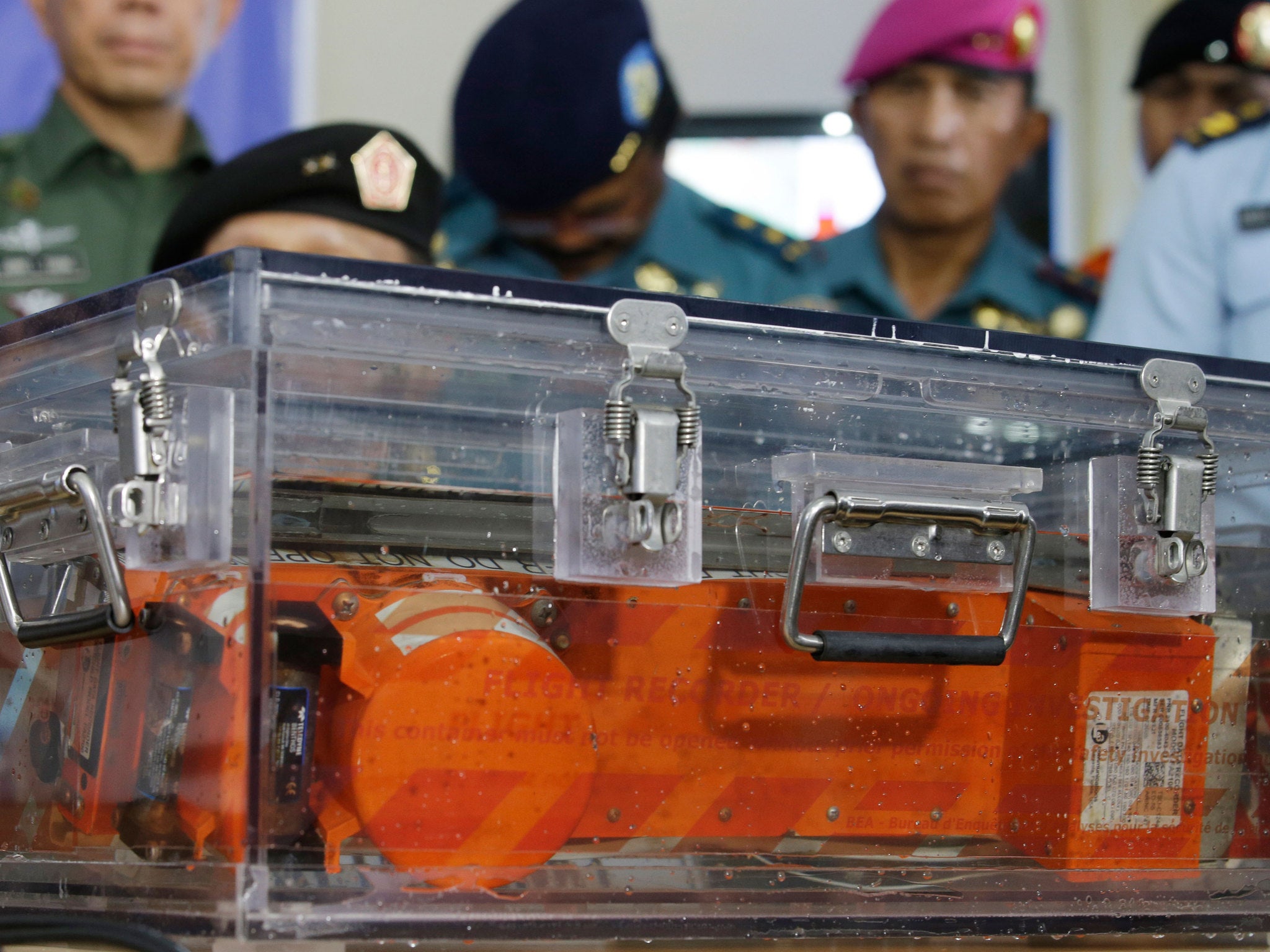 A black box of the ill-fated AirAsia Flight 8501 that crashed in the Java Sea, is briefly displayed at airport in Pangkalan Bun, Indonesia, Monday, Jan. 12, 2015.