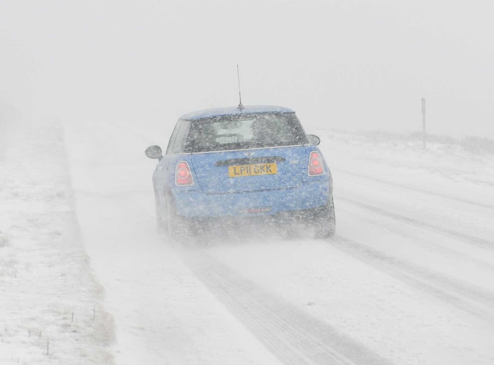 A car drives through heavy snow in March last year