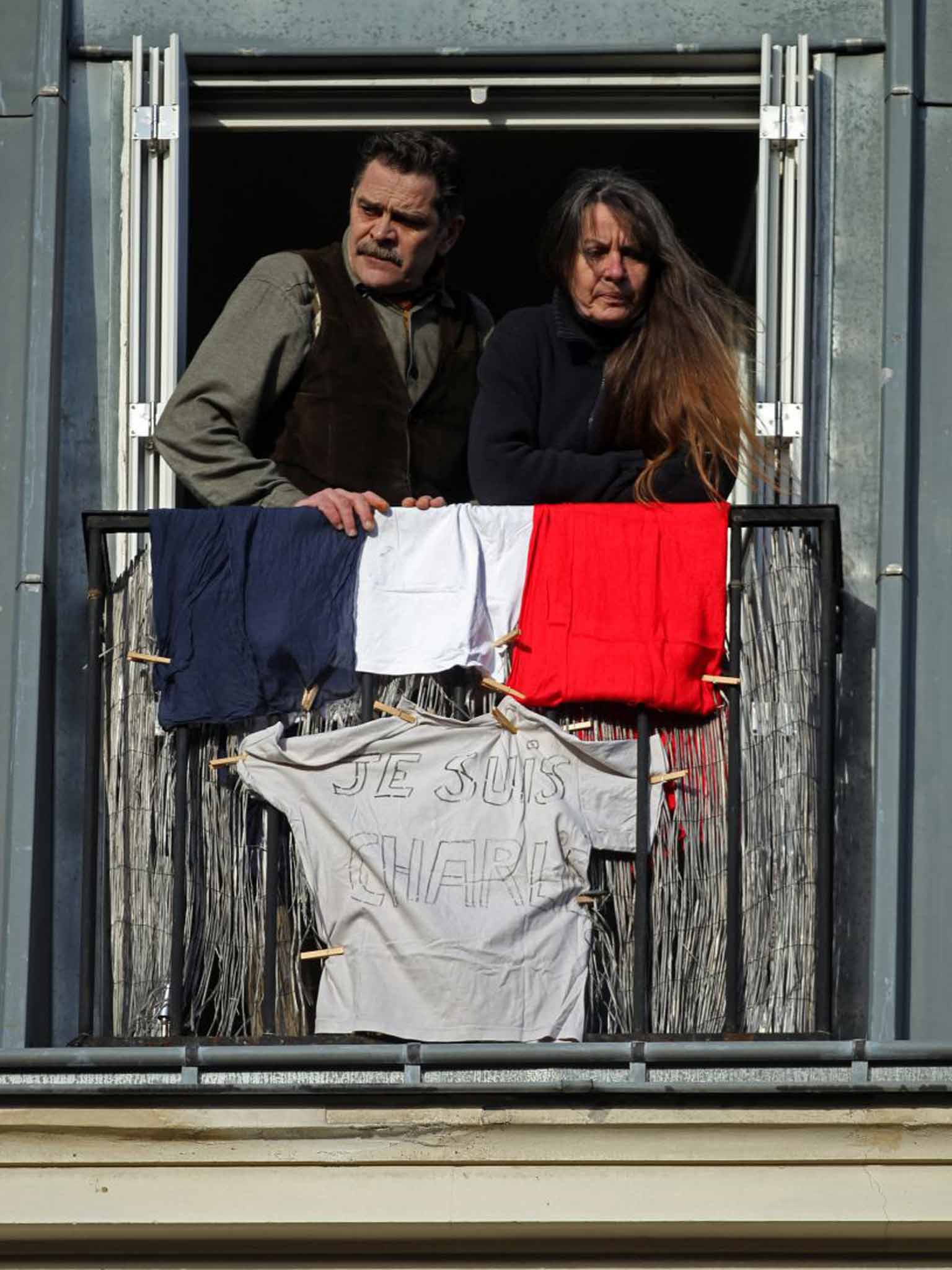 Us tous: Parisien couple show off their Tricolour and support for Je Suis Charlie movement