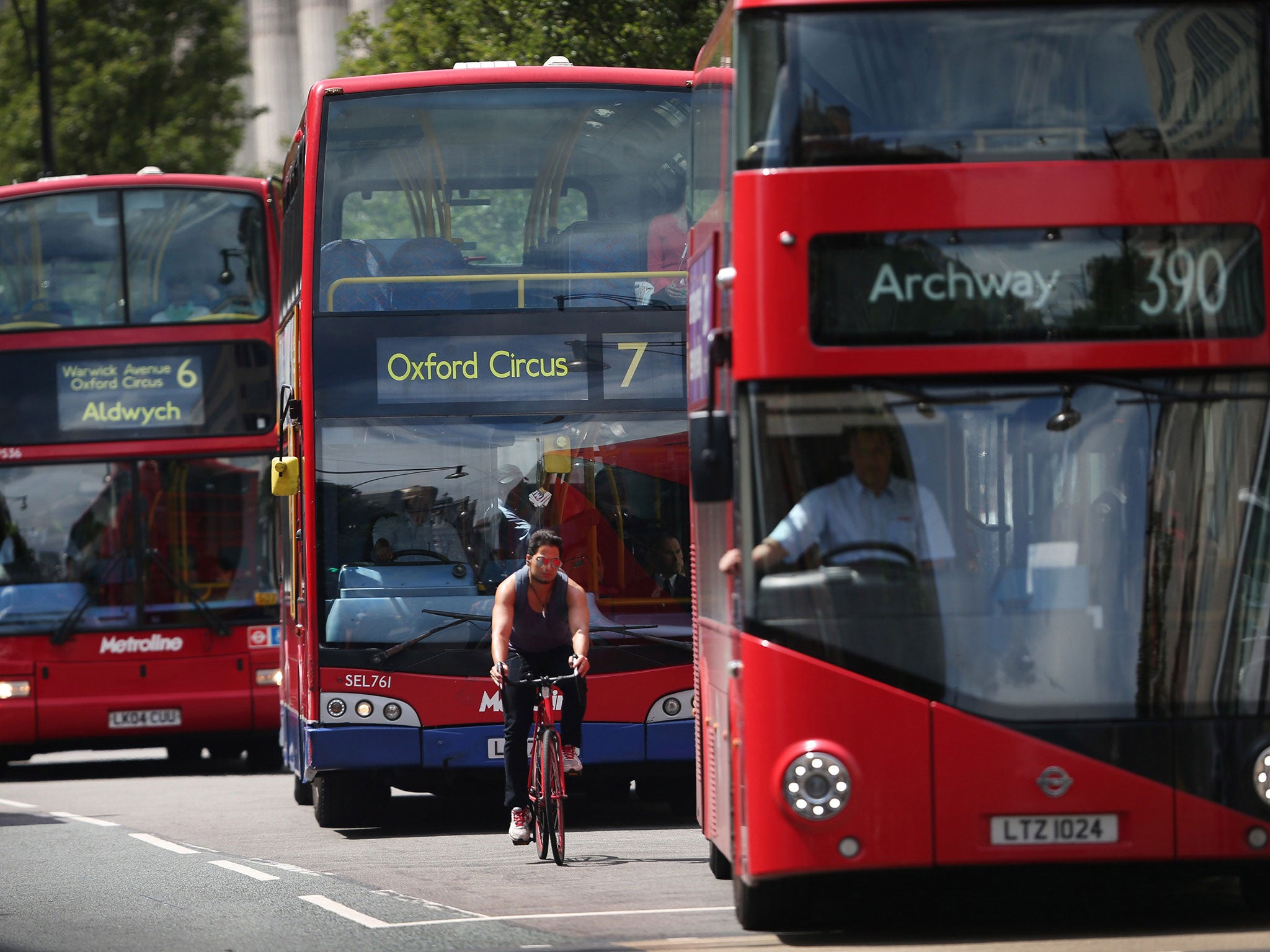 A cyclist passes buses in Oxford Street