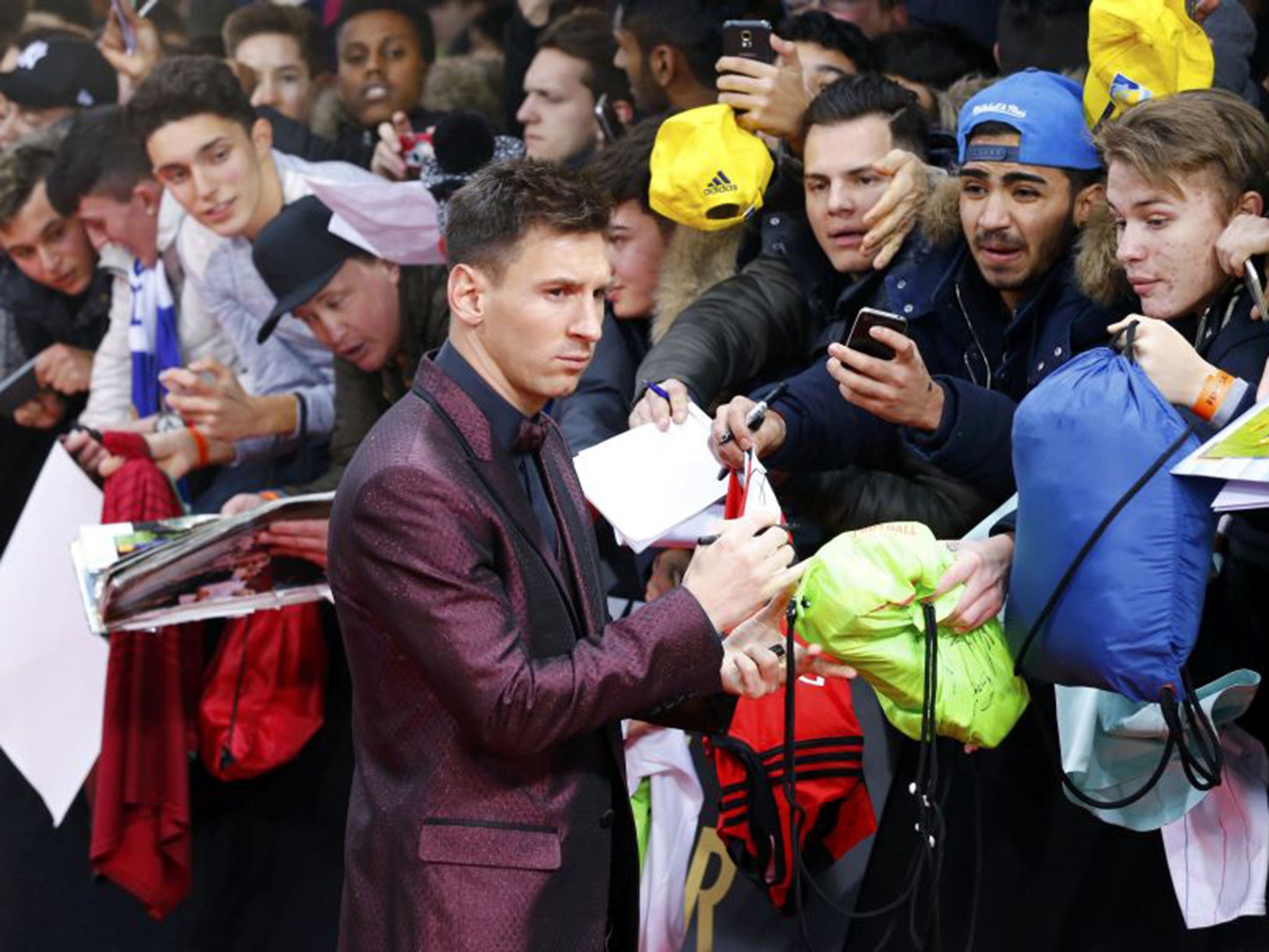 Lionel Messi signs autographs outside the Ballon d’Or ceremony in Zurich on Monday (Reuters)