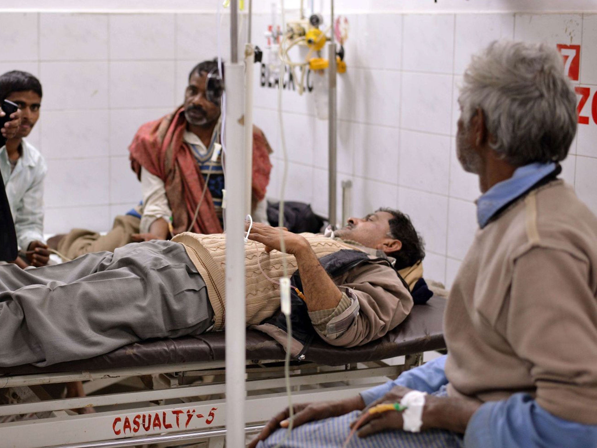 An alcohol poisoning patient receives treatment at the King George Medical College Hospital in Lucknow on January 12