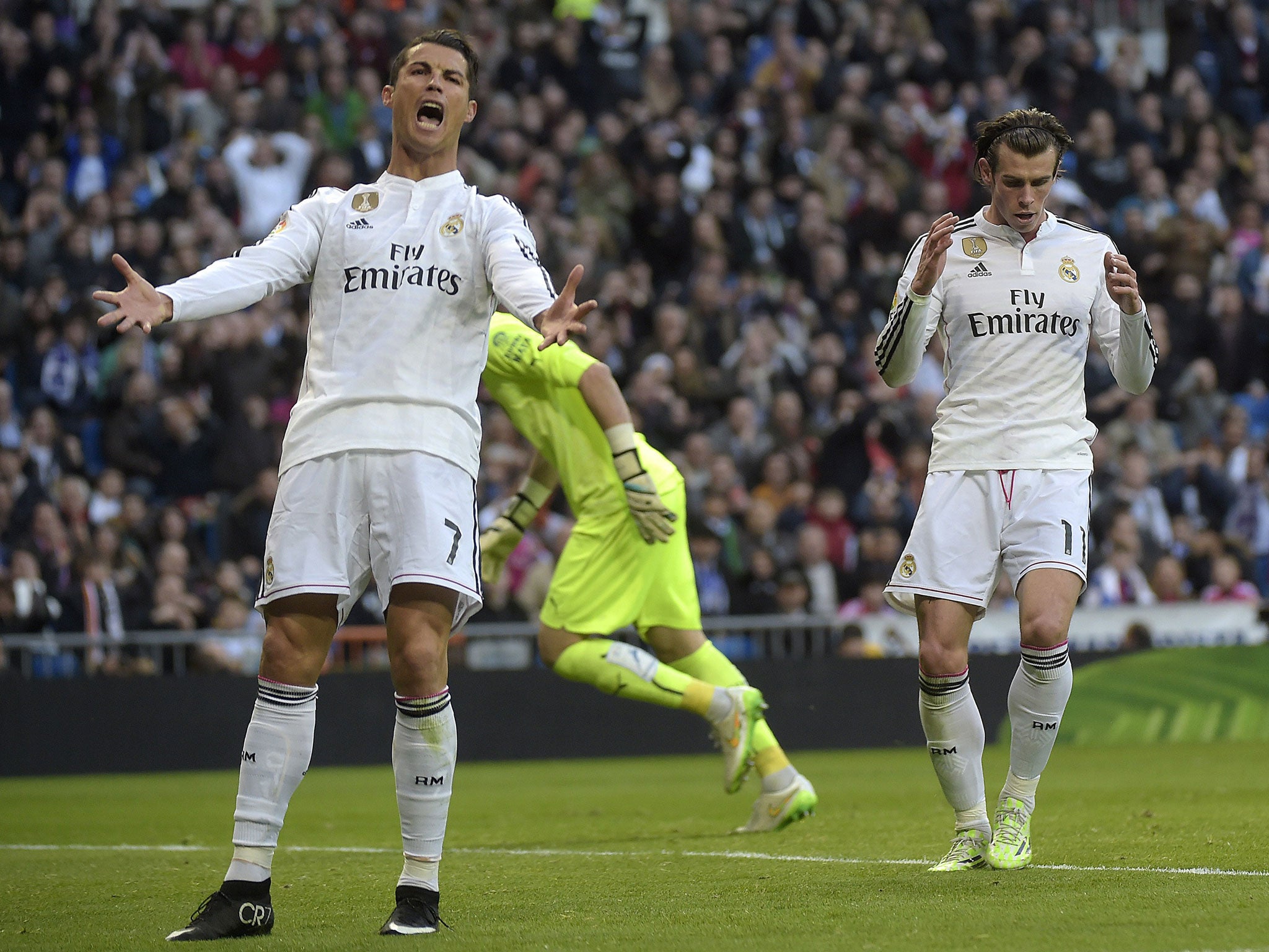 Cristiano Ronaldo gestures after Gareth Bale goes for goal instead of passing to him