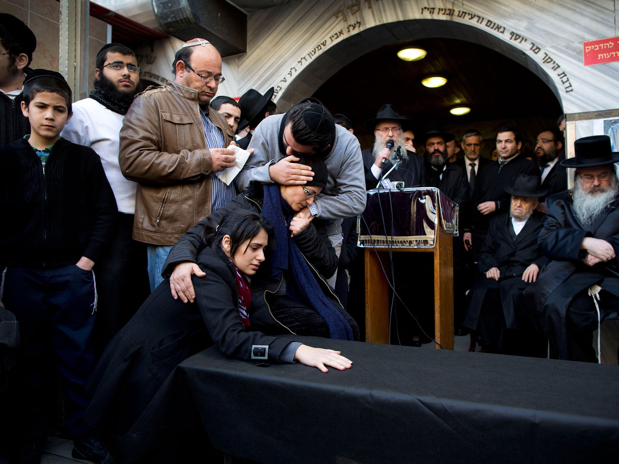 Family and relatives of French Jew Yoav Hattab, a victim of the attack on a kosher grocery store in Paris, gather around a symbolic coffin for his funeral procession in the city of Bnei Brak near Tel Aviv, Israel