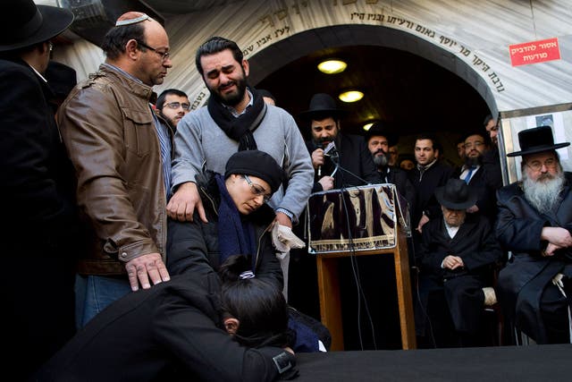 Family and relatives of French Jew Yoav Hattab, a victim of the attack on kosher grocery store in Paris, gather around a symbolic coffin for his funeral procession in the city of Bnei Brak near Tel Aviv, Israel 