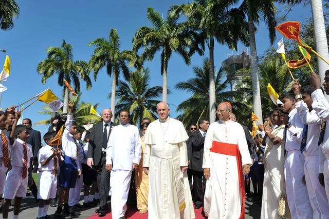 Pope Francis, centre, arrives at Colombo's International airport, Sri Lanka