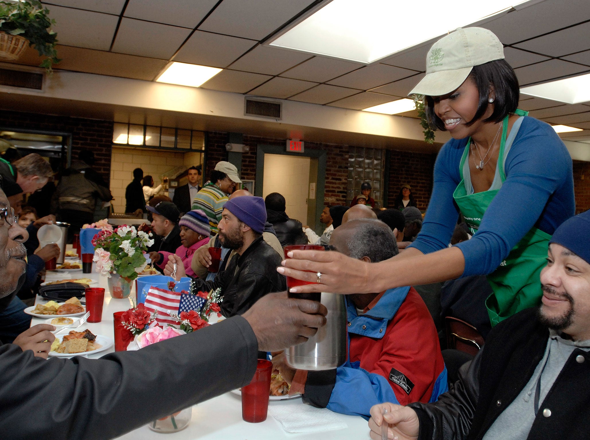 Michelle Obama serving at a homeless soup kitchen in Washington in 2010