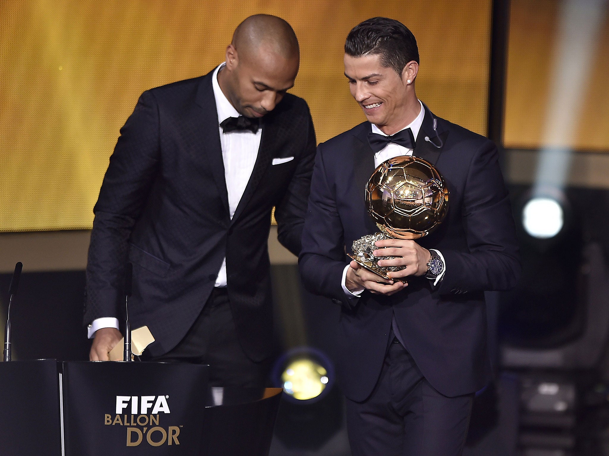 Cristiano Ronaldo (right) receives the Ballon d'Or award from Thierry Henry last January