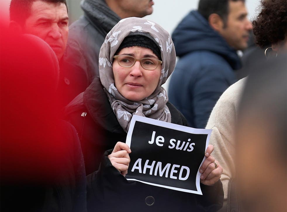 A mourner holds a sign saying 'Je suis Ahmed' (I am Ahmed) during the funeral of murdered police officer Ahmed Merabet,  in Bobigny, France