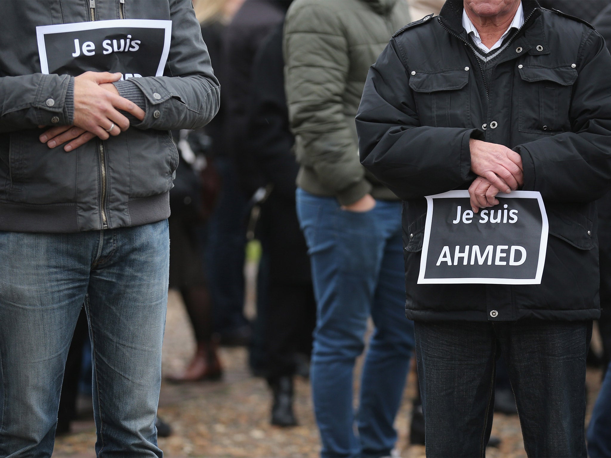 Mourners hold signs saying 'Je suis Ahmed' (I am Ahmed) during the funeral of murdered police officer Ahmed Merabet, in Bobigny, France