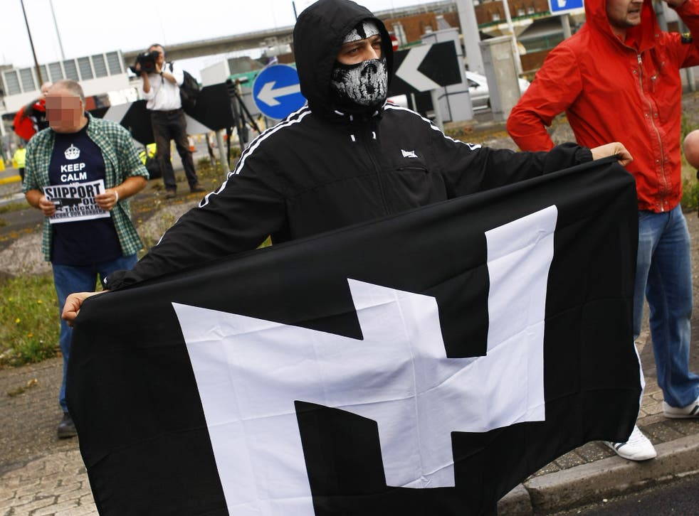 A demonstrator holds a neo-Nazi flag during a rally last September