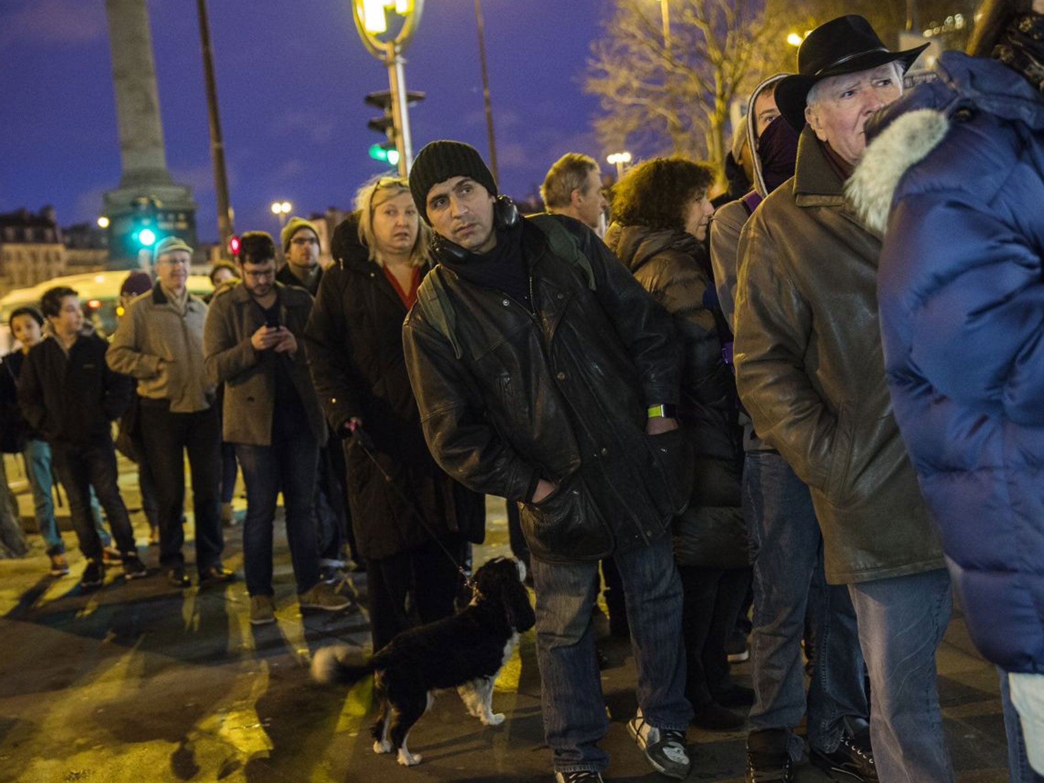 People queue at a newspaper kiosk to buy latest edition of Charlie Hebdo