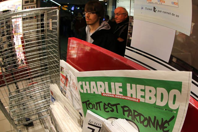 People wait to buy the latest issue of Charlie Hebdo newspaper at a newsstand in Rennes 