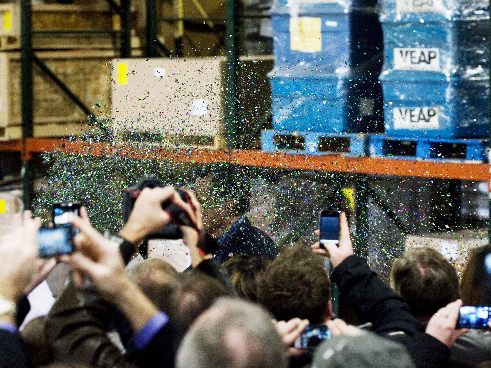 Glitter is tossed into the air as Mitt Romney makes his way toward the stage during a rally in 2012