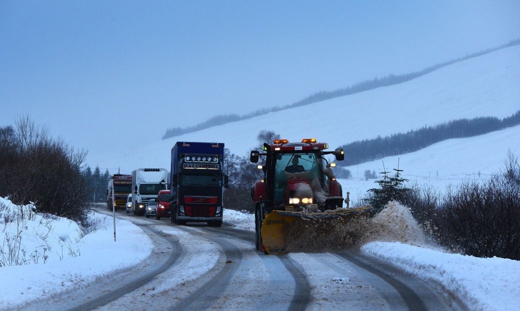 A snow plough clears the road as driving conditions become difficult on the A82 this morning in Tyndrum Scotland.