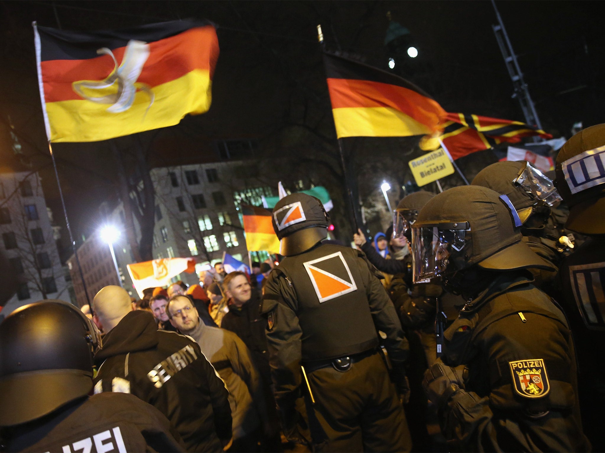 Supporters of the Pegida movement wave German flags during their protest in Dresden, Germany, on Monday