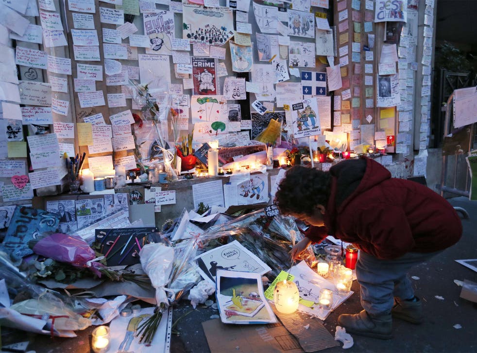 Dave Brown’s cartoon is among tributes left outside the offices of ‘Charlie Hebdo’