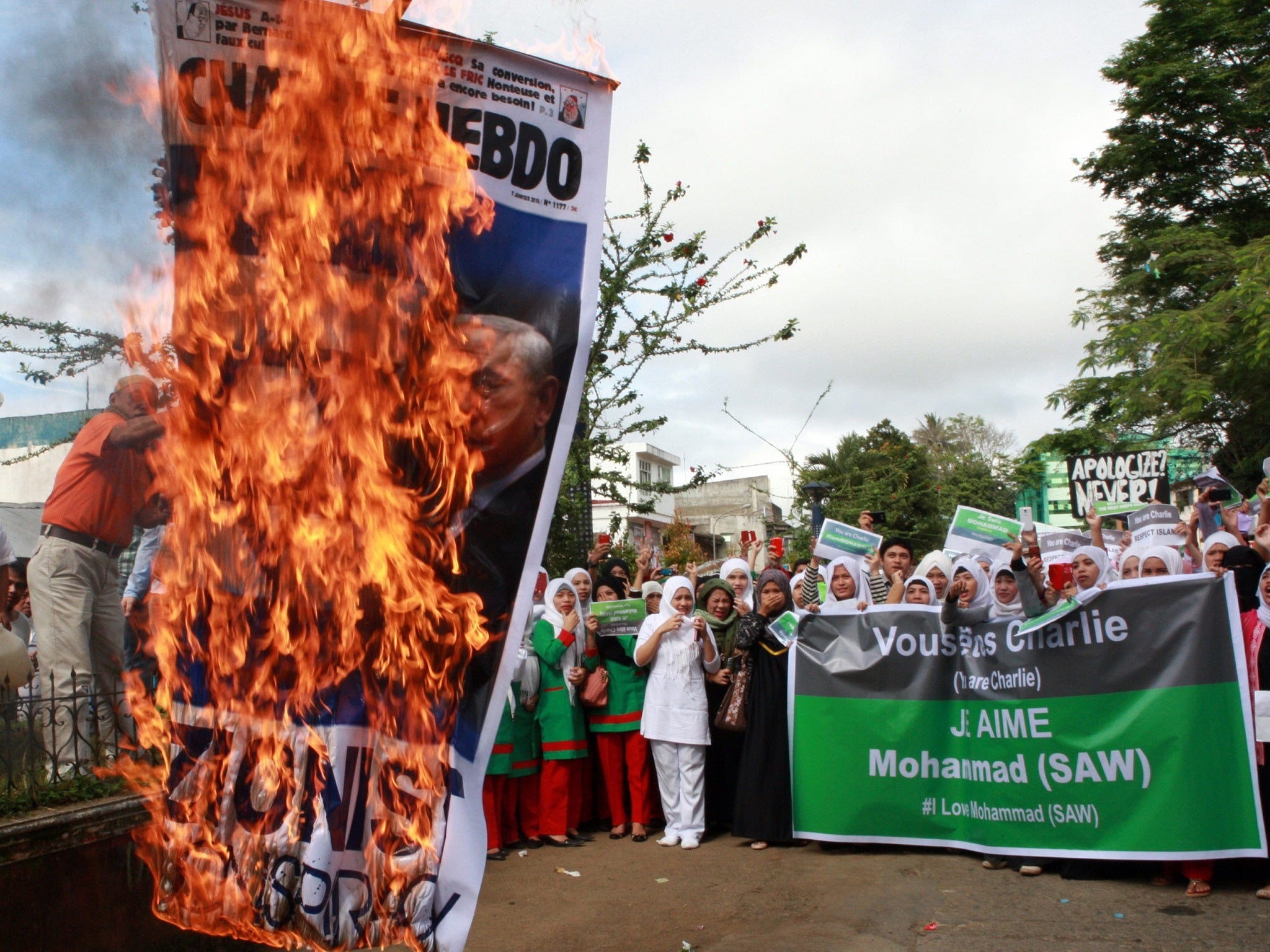 Protesters in Marawi, Philippines, burn a poster with the face of Israeli Prime Minister Benjamin Netanyahu