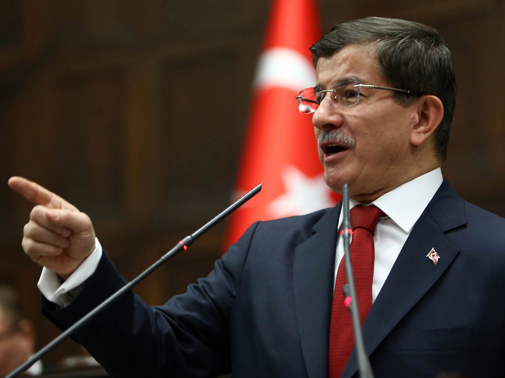 Turkey's Prime Minister Ahmet Davutoglu speaks during the parliamentary group meeting of Turkey's ruling Justice and Development Party at the Grand National Assembly of Turkey on January 13, 2015