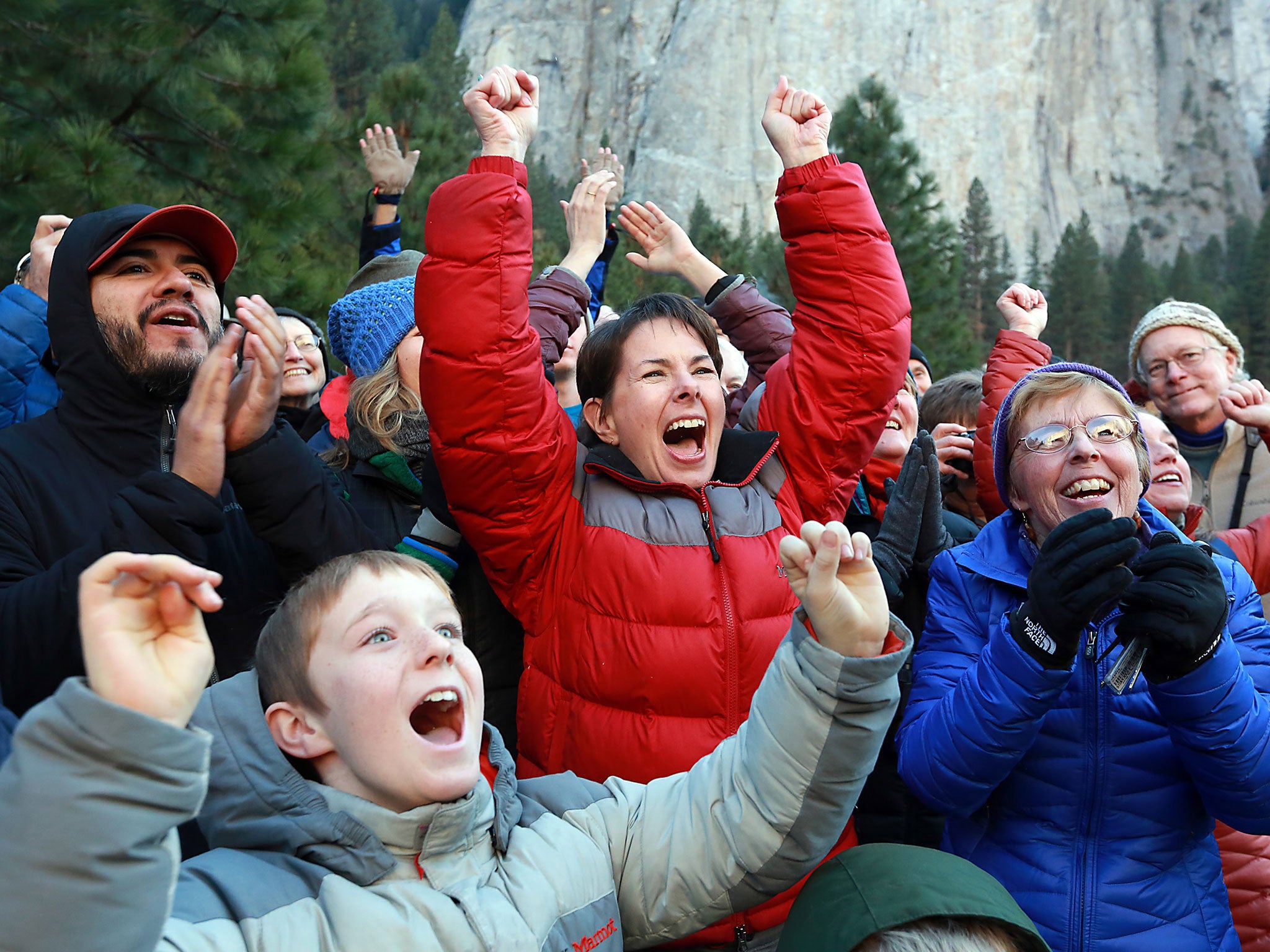 People cheer as climbers complete a free climb of El Capitan in the Yosemite Valley