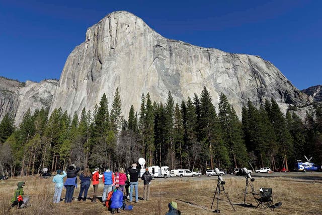 Spectators gaze at El Capitan for a glimpse of climbers Tommy Caldwell and Kevin Jorgeson, as seen from the valley floor in Yosemite National Park 