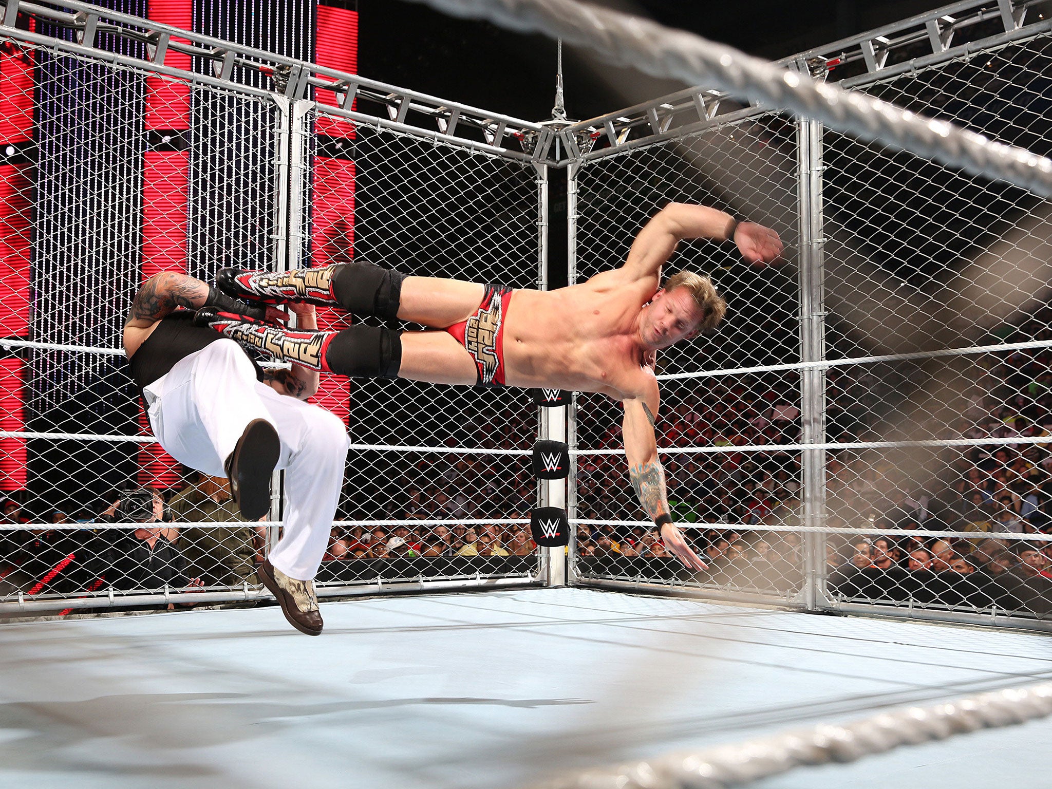 Jericho lands a drop kick on Bray Wyatt in a cage match