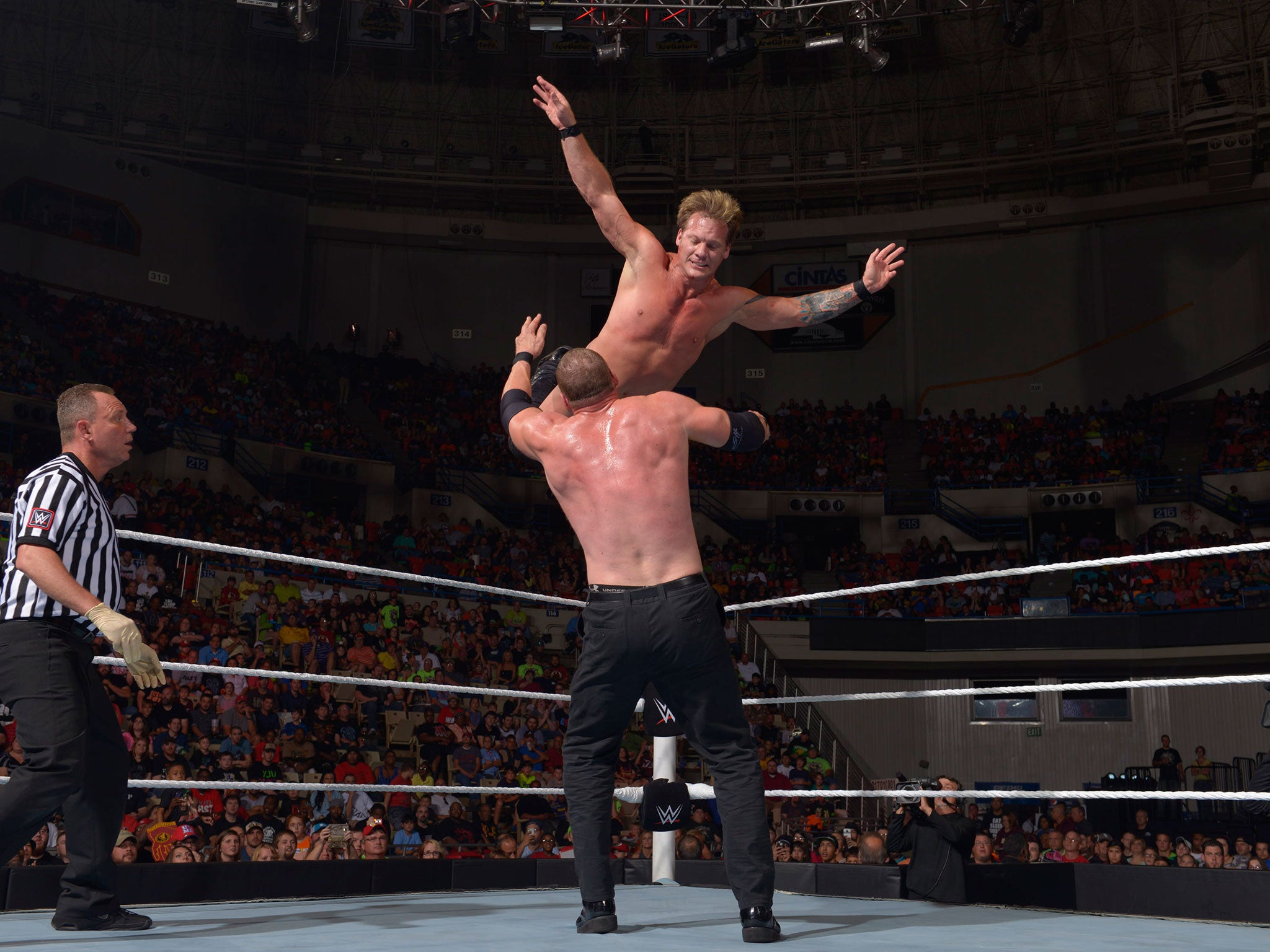 Jericho jumps from the top rope with onto Kane