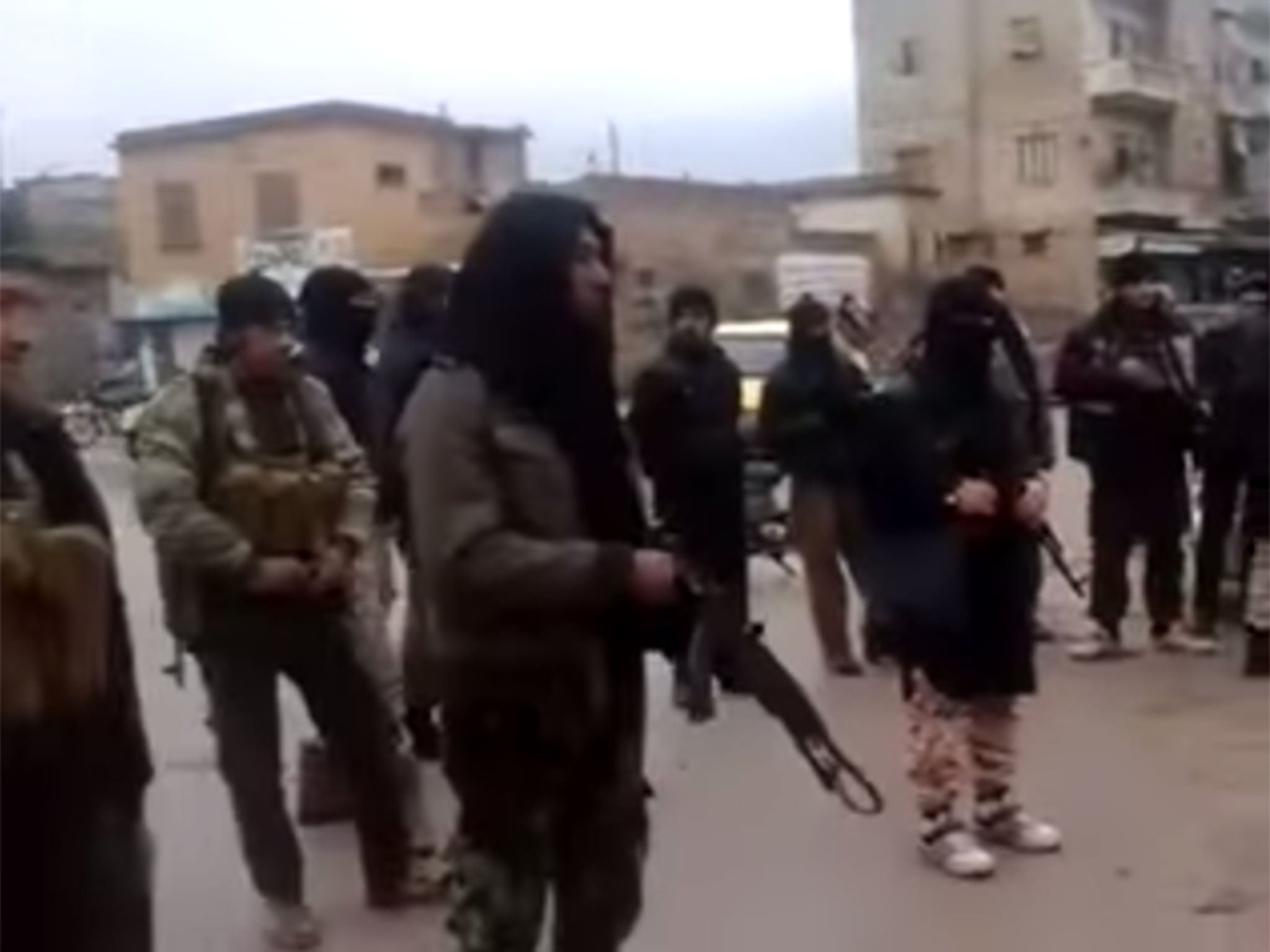 The video starts with a wide shot showing a square full of heavily-armed jihadists