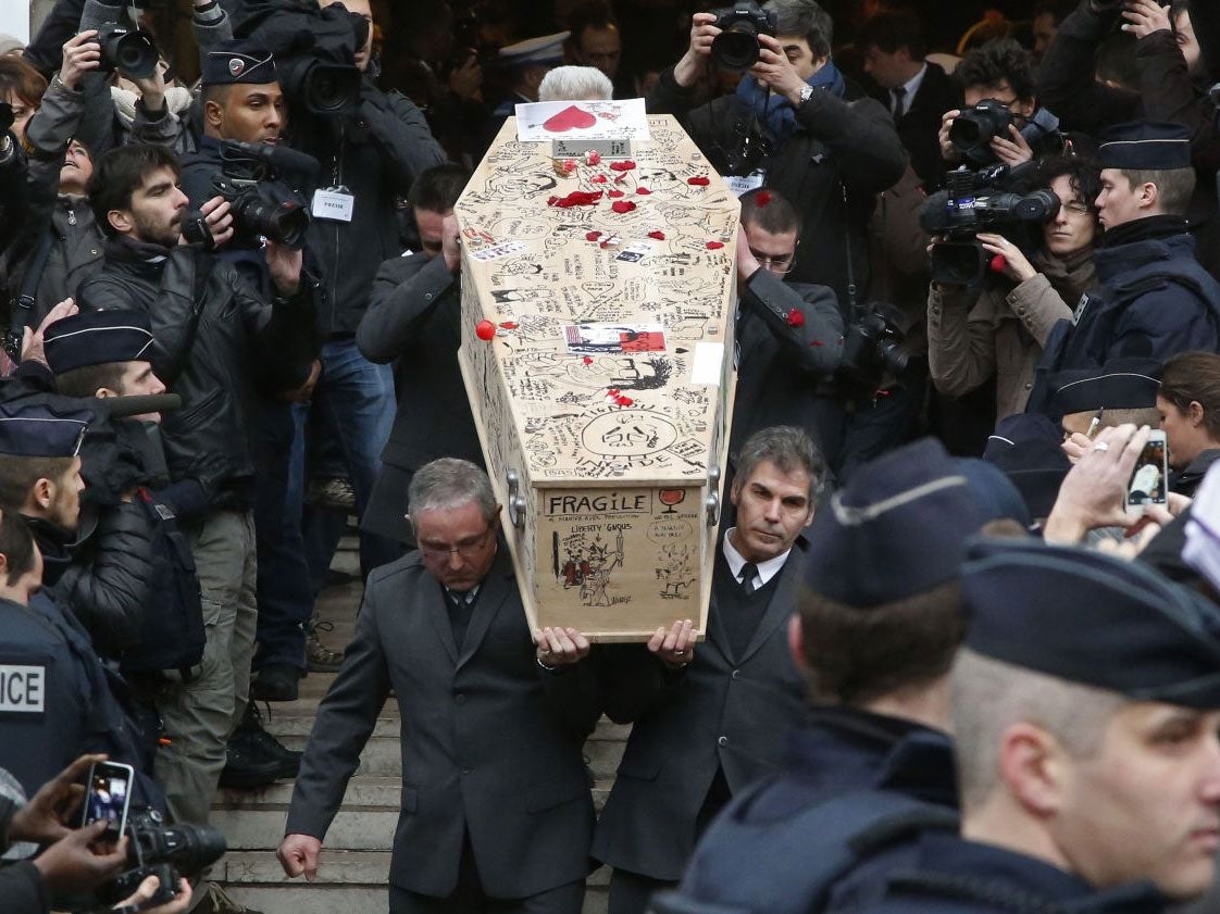 Pallbearers carry the casket of Charlie Hebdo cartoonist Bernard Verlhac, known as Tignous, decorated by friends and colleagues of the satirical newspaper Charlie Hebdo, at the city hall of Montreuil, outside east of Paris