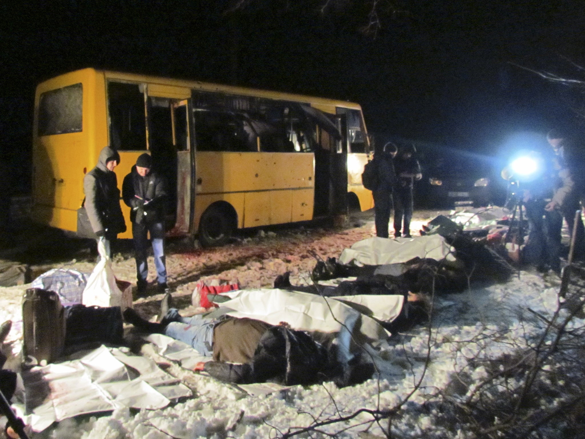 The bodies of the victims of a shelling attack on a bus near the Ukraine town of Volnovakha
on Tuesday are laid out by the side of the Donetsk-Mariupol road