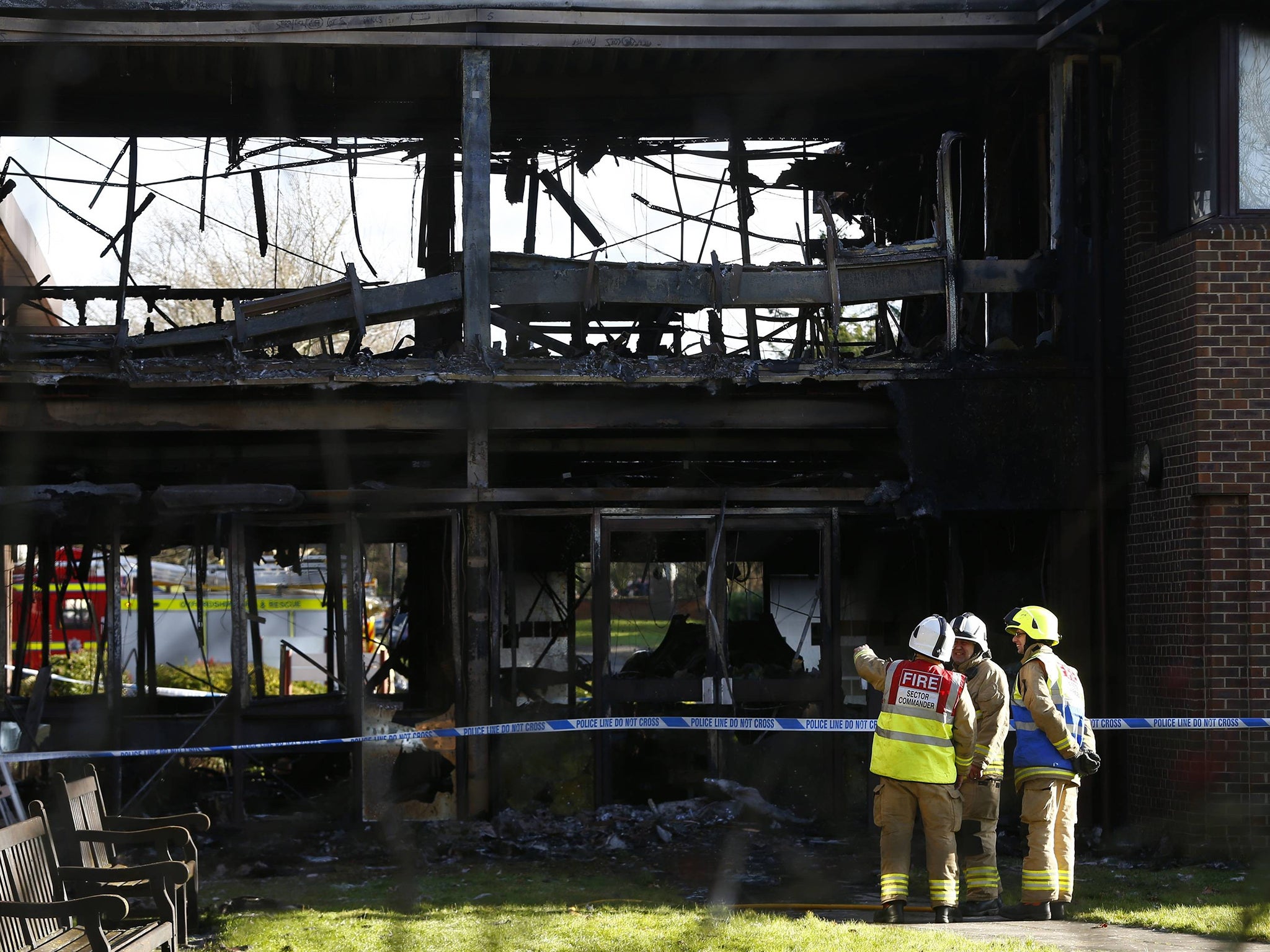 Firefighters assess the damage at the scene of the firebombing at the South Oxfordshire
District Council building