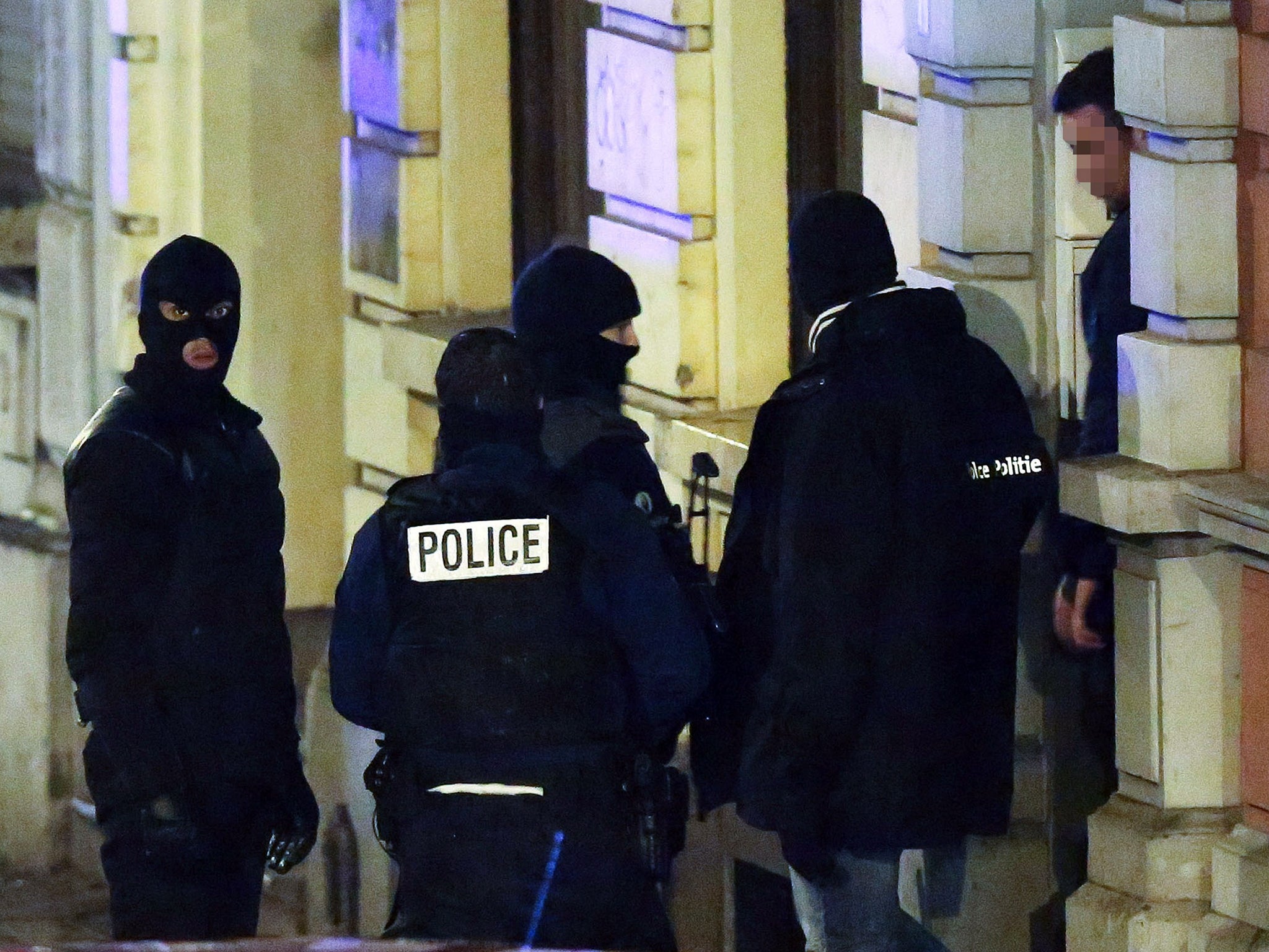 Belgian police exit a building in Palais street, near Colline street in Verviers, eastern Belgium