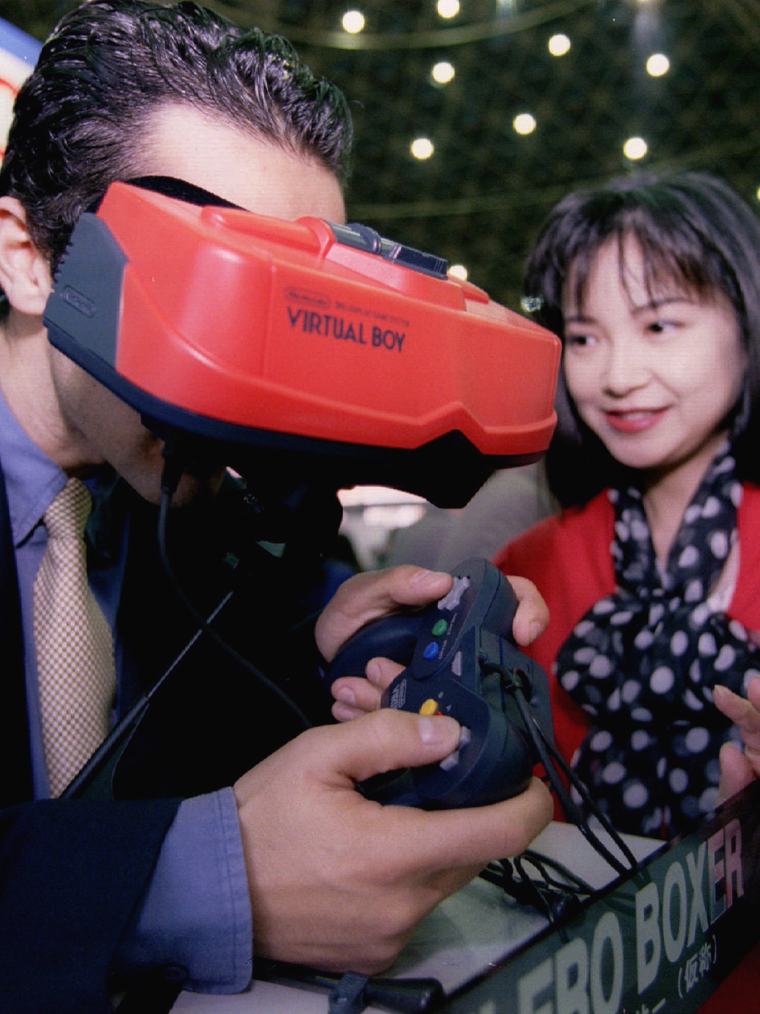 A visitor to a Tokyo software exhibition samples Nintendo's 32-bit "Virtual Boy" three dimensional virtual reality videogame system in 1994