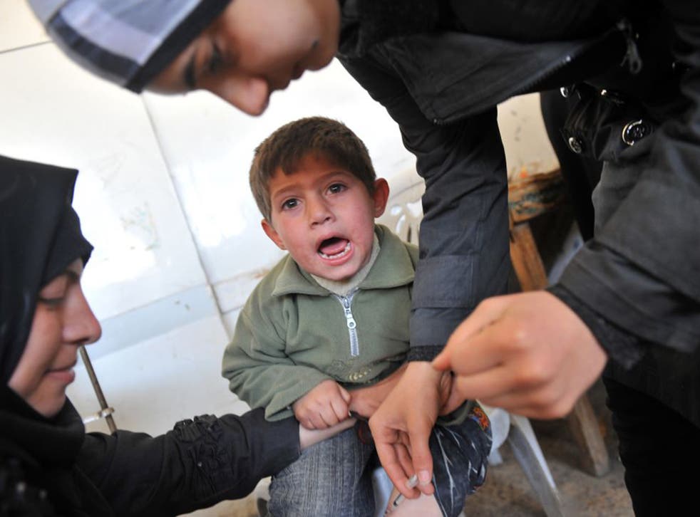 Innoculating a Syrian child against the disfiguring disease leishmaniasis in Aleppo (AFP/Getty)