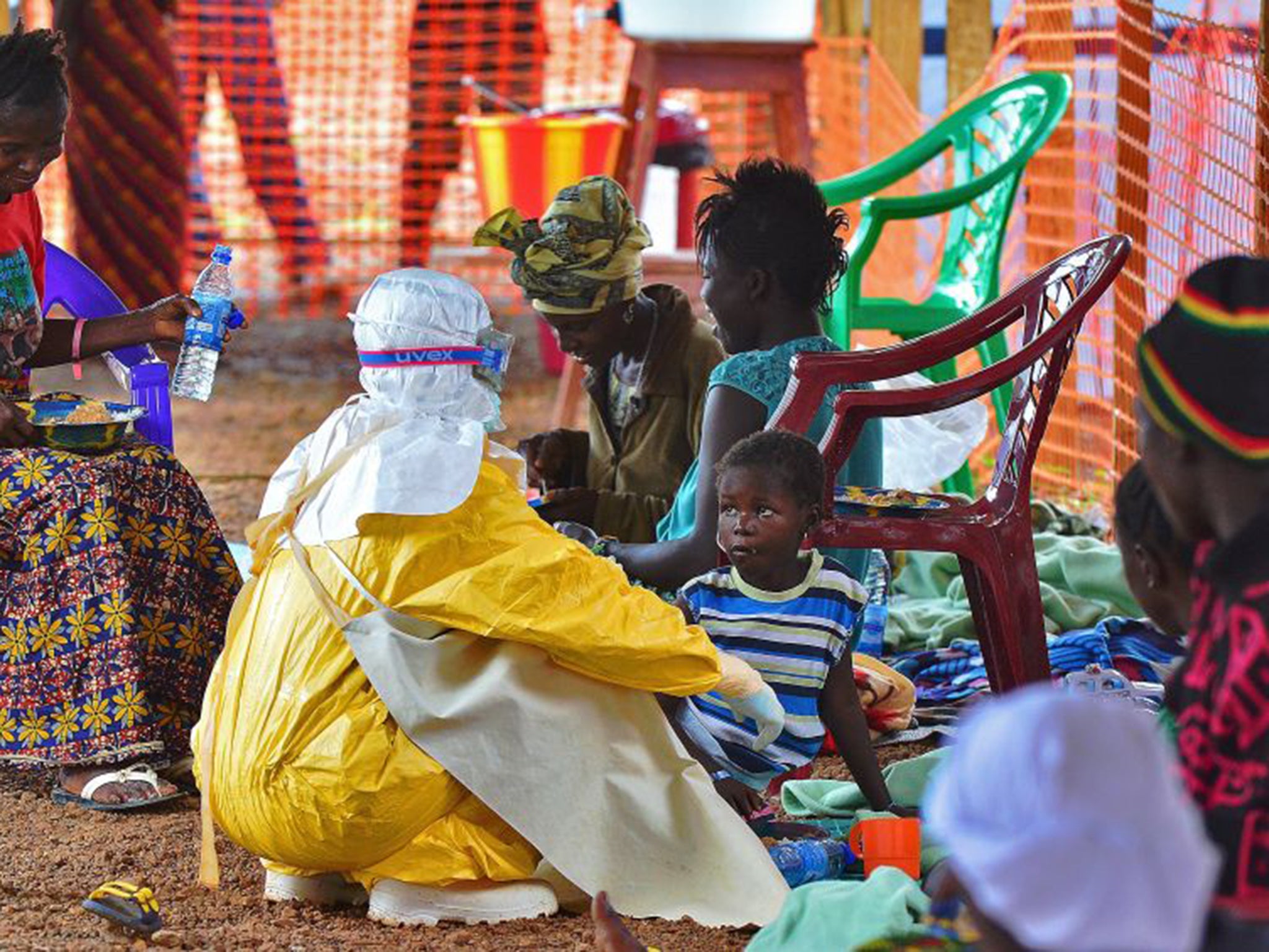 A medic feeds a child victim of Ebola in Sierra Leone (AFP/Getty)