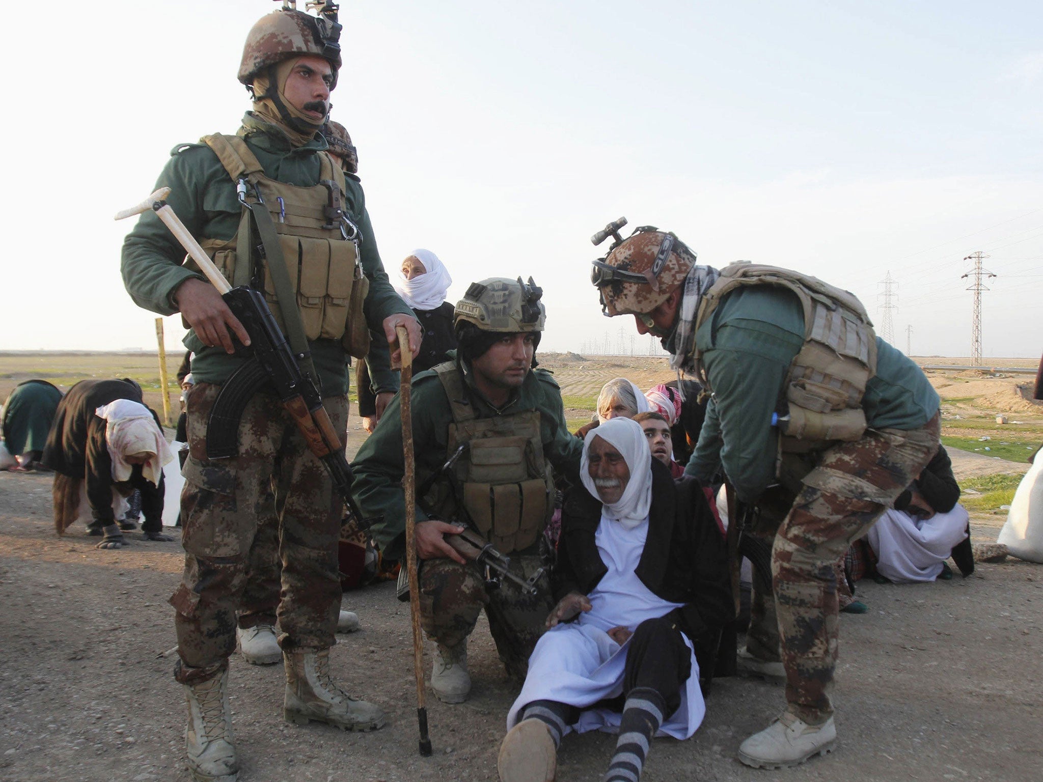Kurdish security forces help people from the minority Yazidi sect, on the outskirts of Kirkuk January 17, 2015